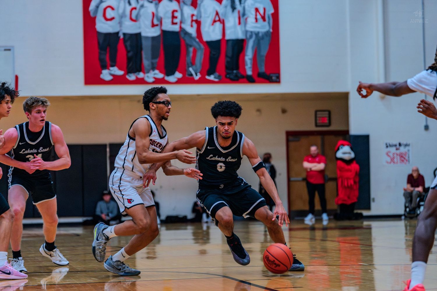 Basketball player #0 drives toward the basket past a defender during a high school game at Colerain.