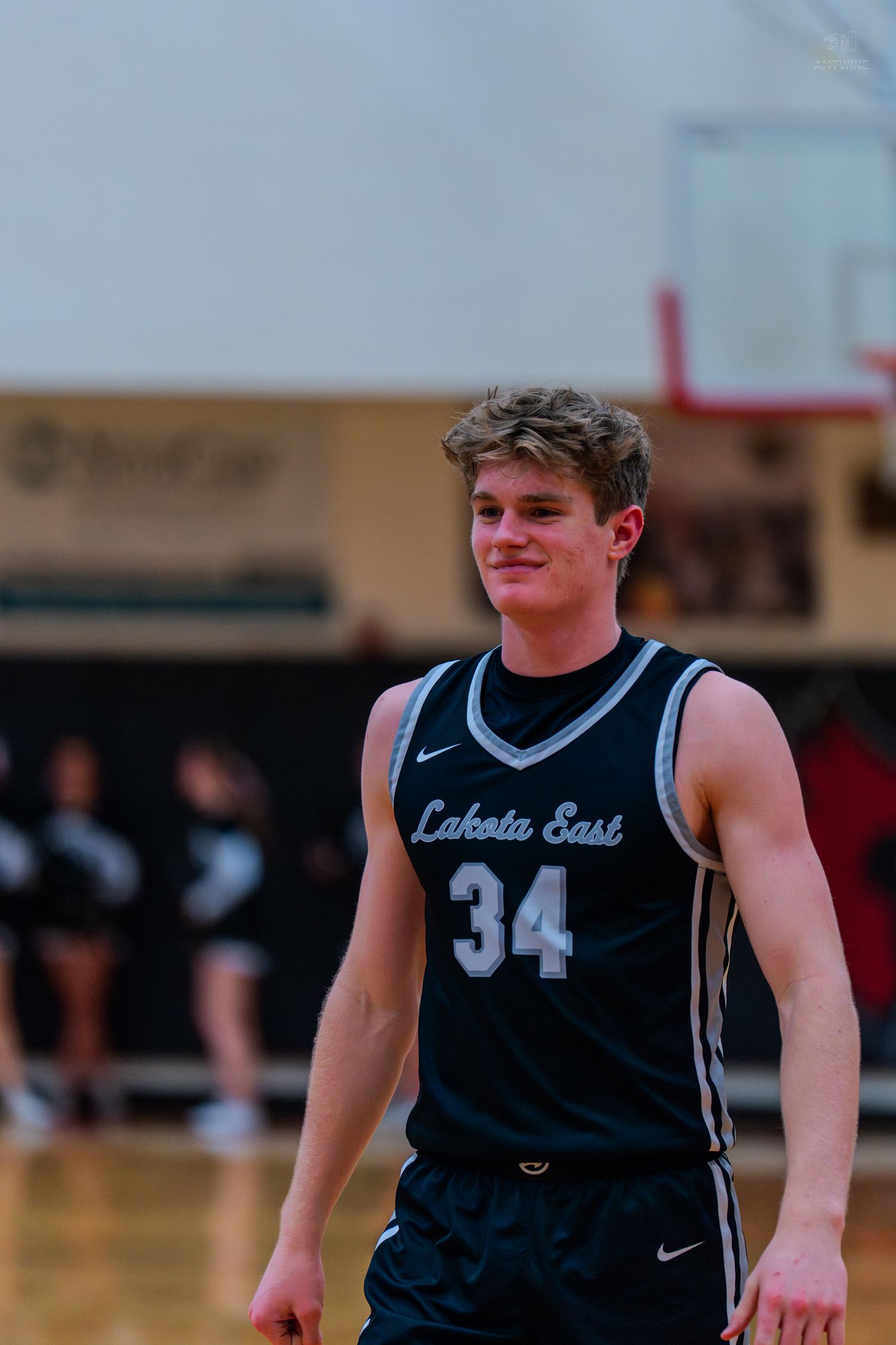 Smiling Lakota East basketball player number 34 during high school game.