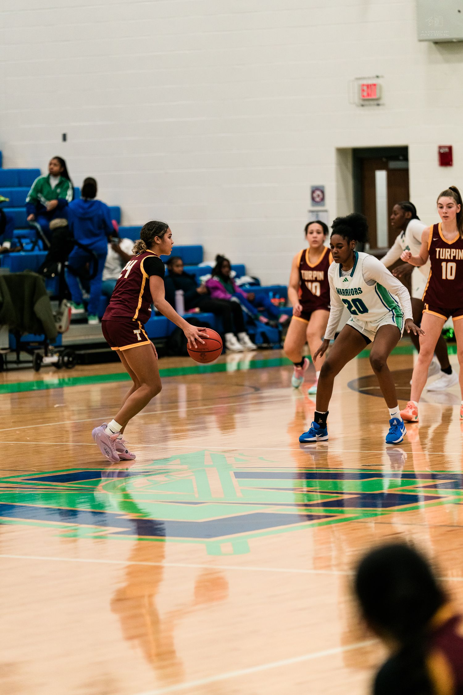 Warriors number 20 defends a Turpin ball handler during a girls high school basketball game.