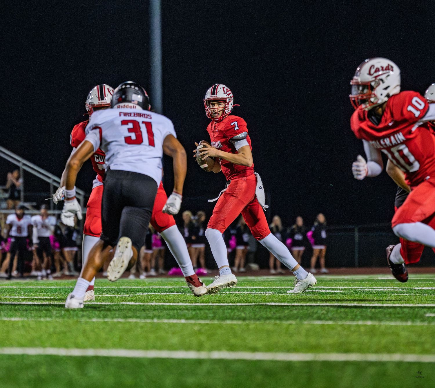 Colerain Cardinals quarterback #7 surveys the field against the Firebirds defense.