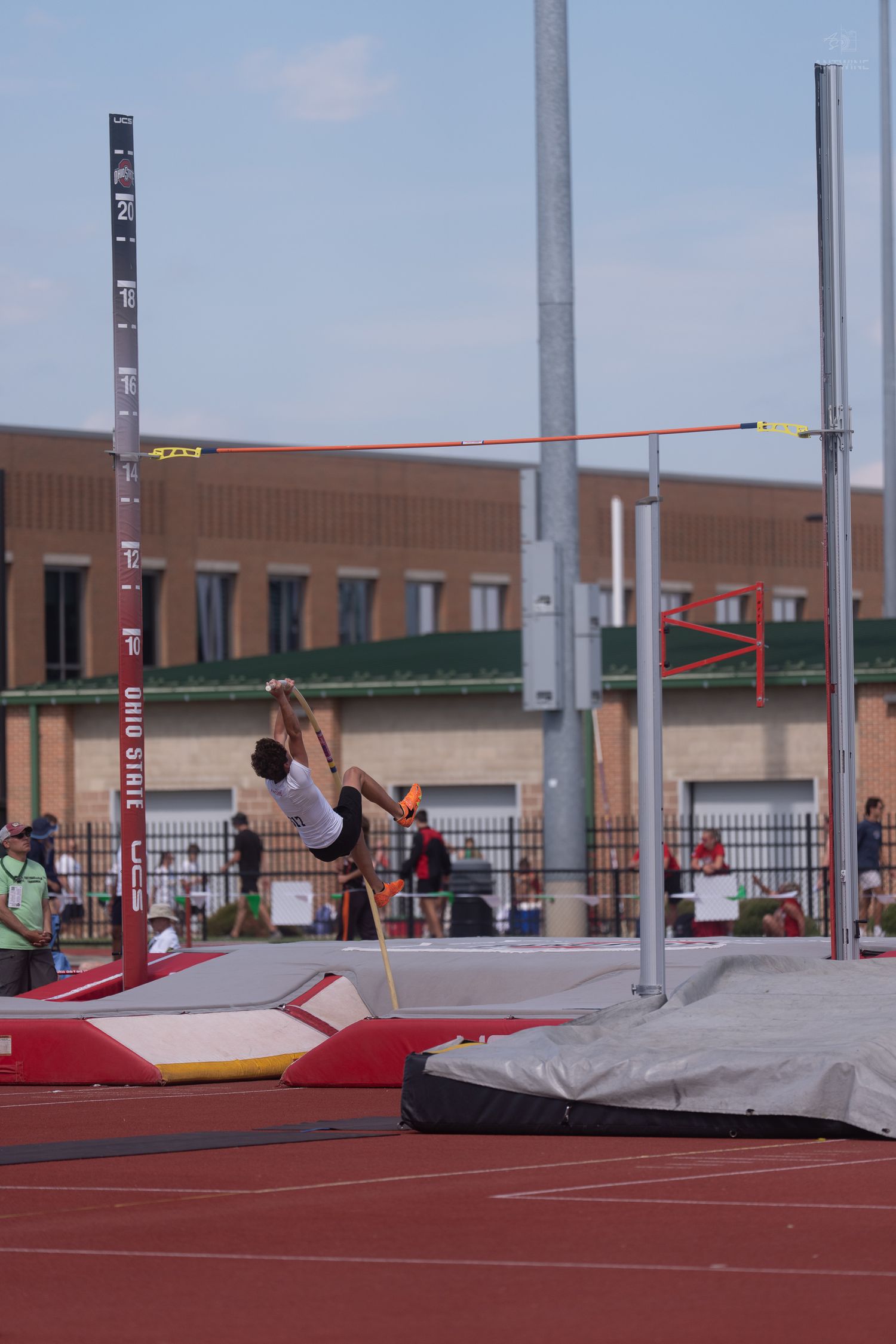 Pole vaulter clears the bar at an Ohio State University outdoor track and field competition.