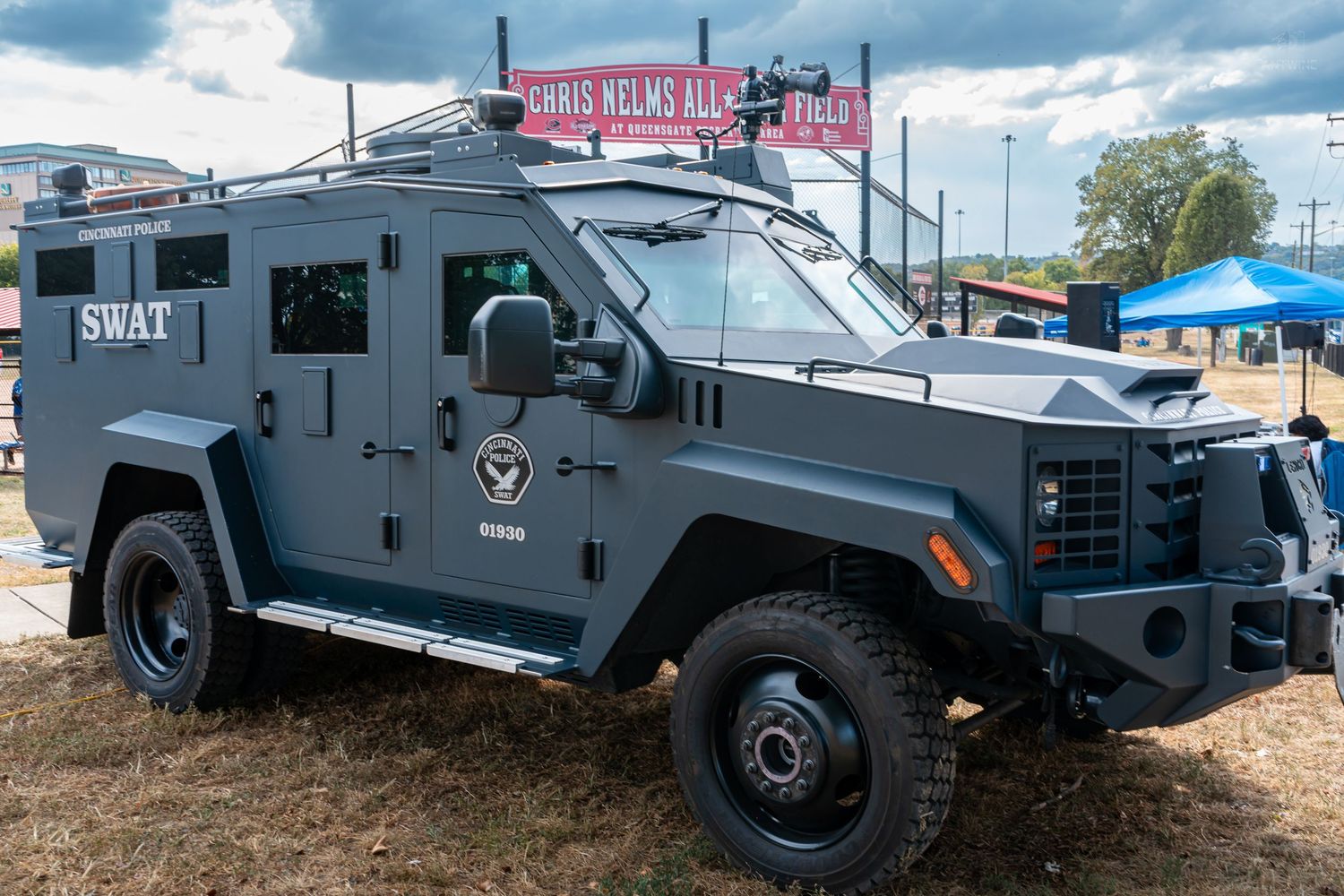Gray SWAT armored tactical vehicle on display at an outdoor public safety event.