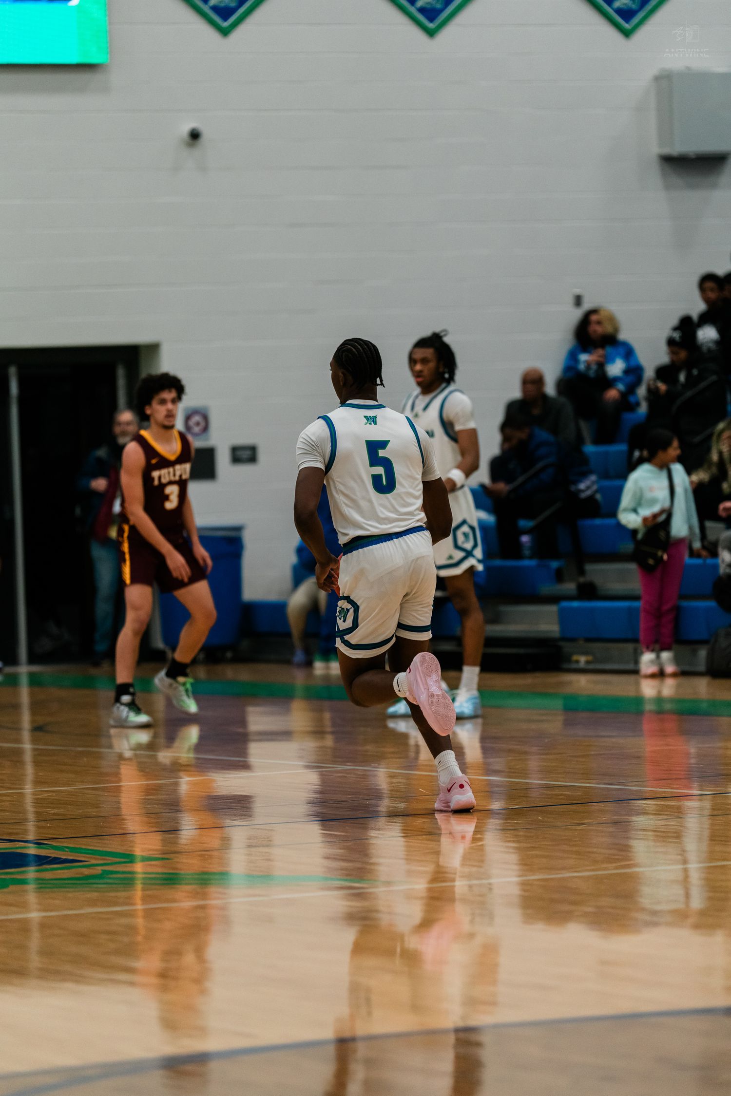 Winton Woods player number 5 in white uniform runs downcourt during a high school basketball game vs Turpin.