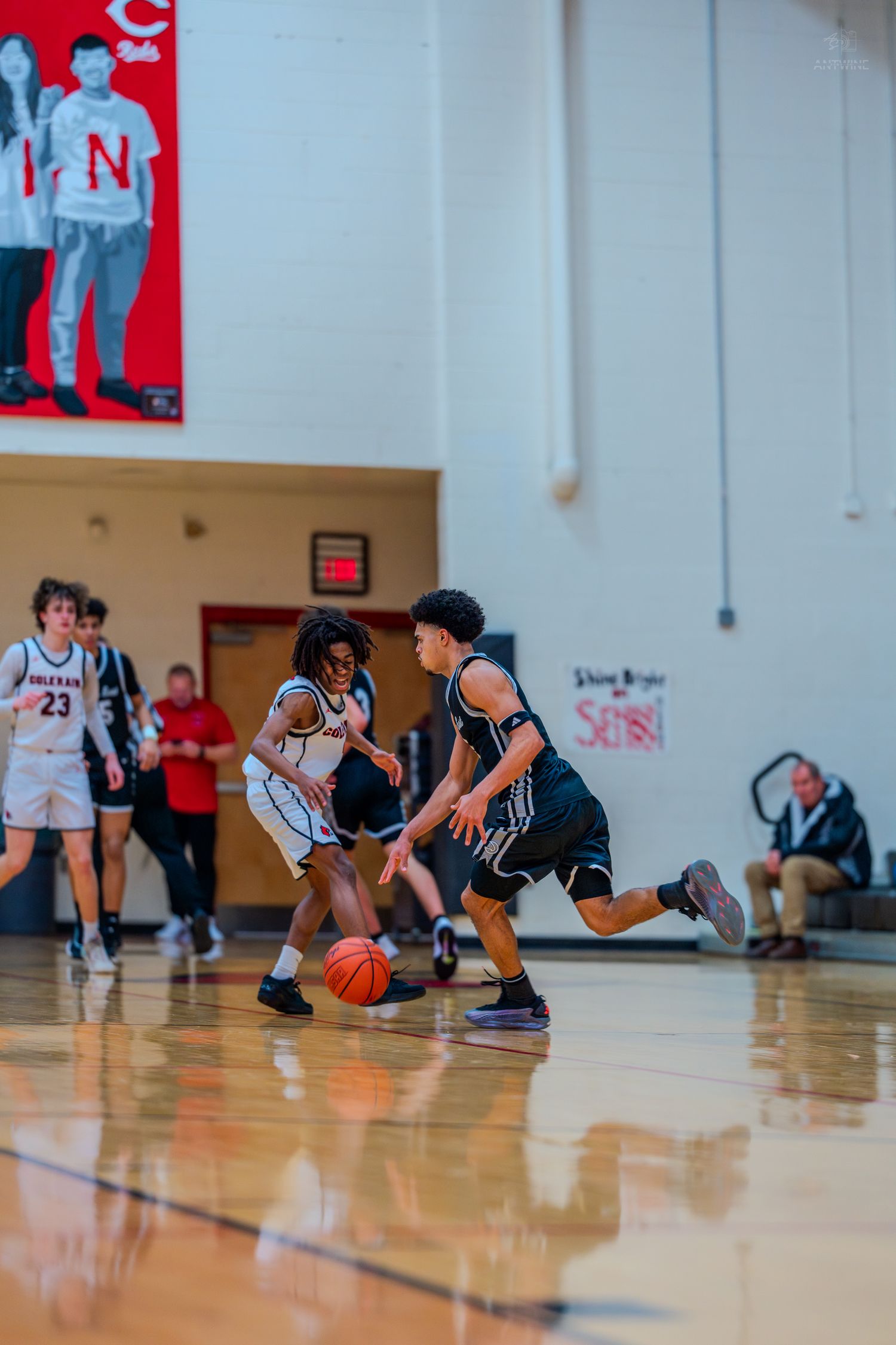 High school basketball players compete for the ball during a game at Colerain gymnasium.