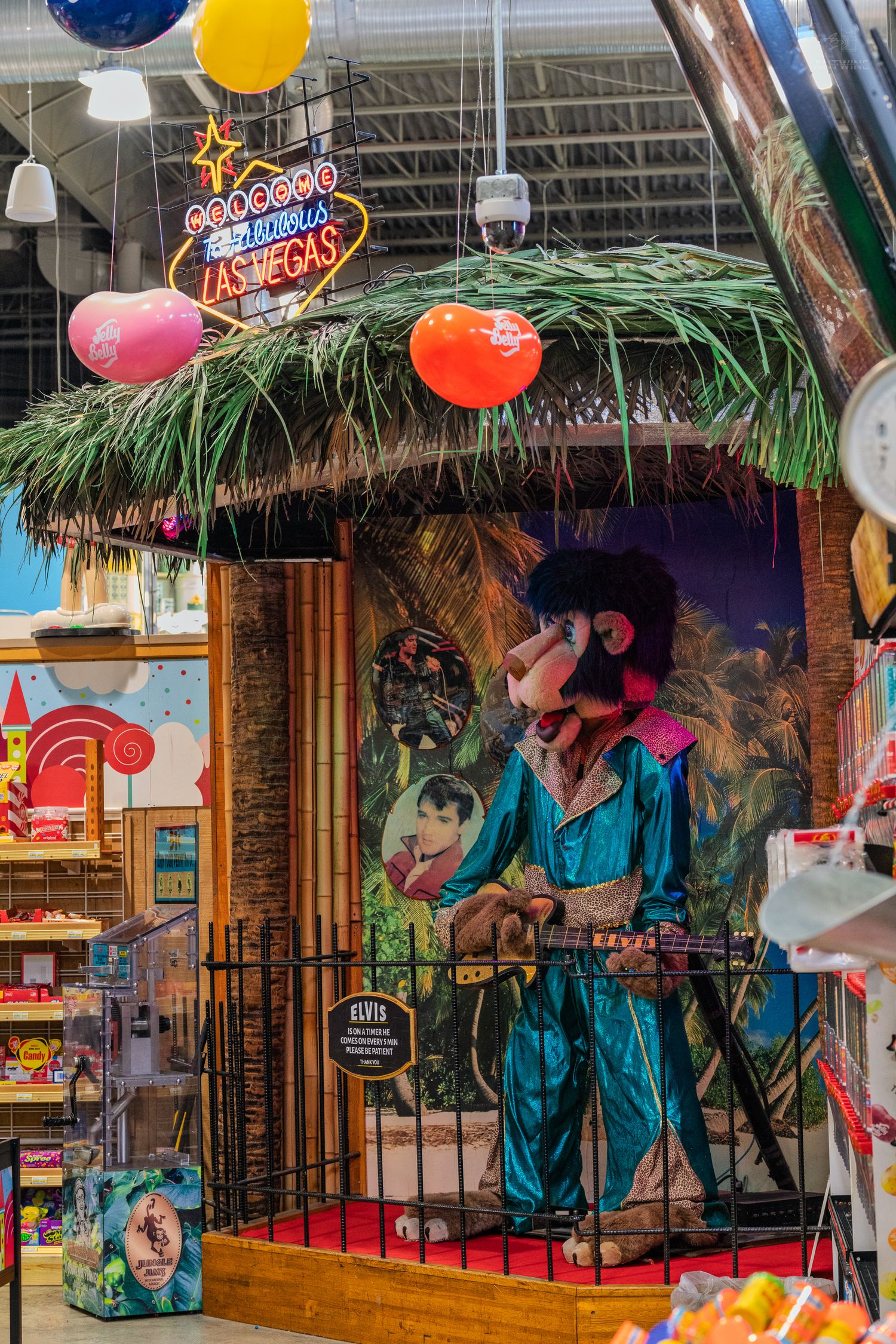 Elvis-themed puppet display with Las Vegas neon sign in a colorful souvenir shop.