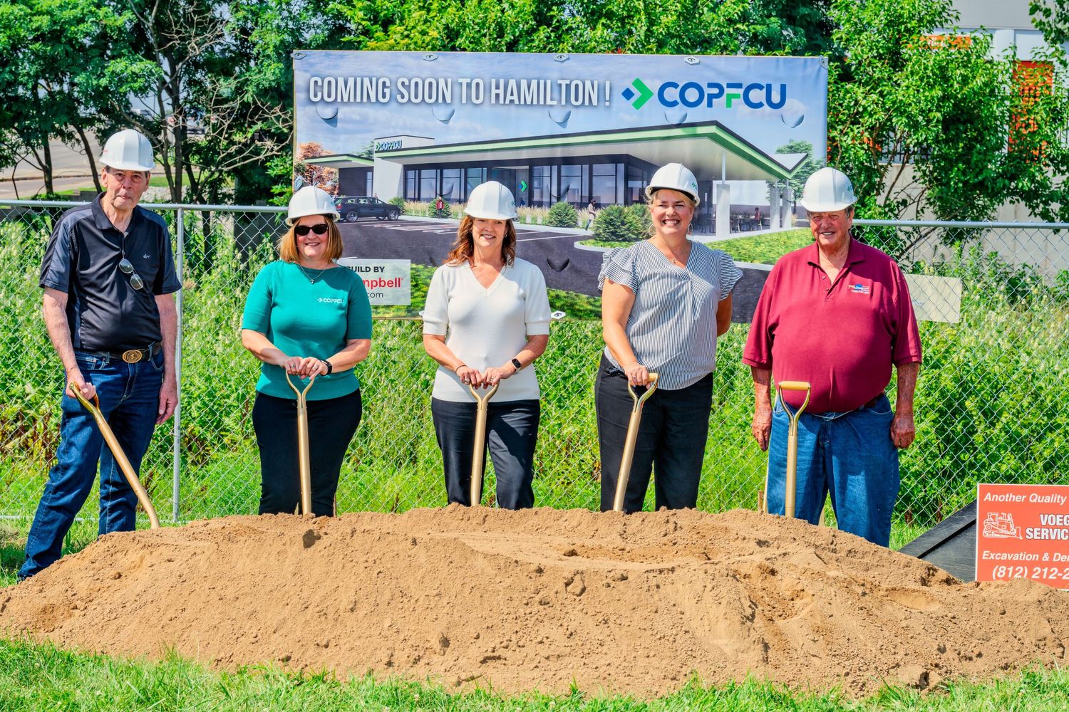 Five people in hard hats with shovels pose at COPFCU Coming Soon to Hamilton groundbreaking event.
