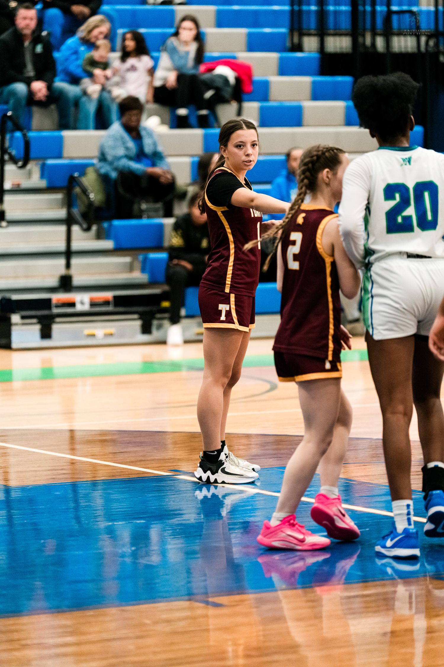 Turpin high school girls basketball player points during a game against the Warriors.