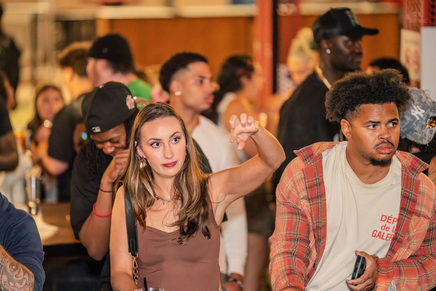 Young couple at a busy indoor social gathering event.