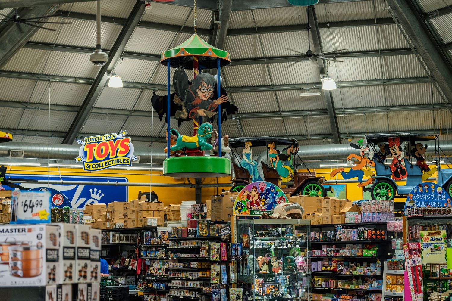 Colorful toy display with hanging carousel decoration inside a bright retail store toy section.
