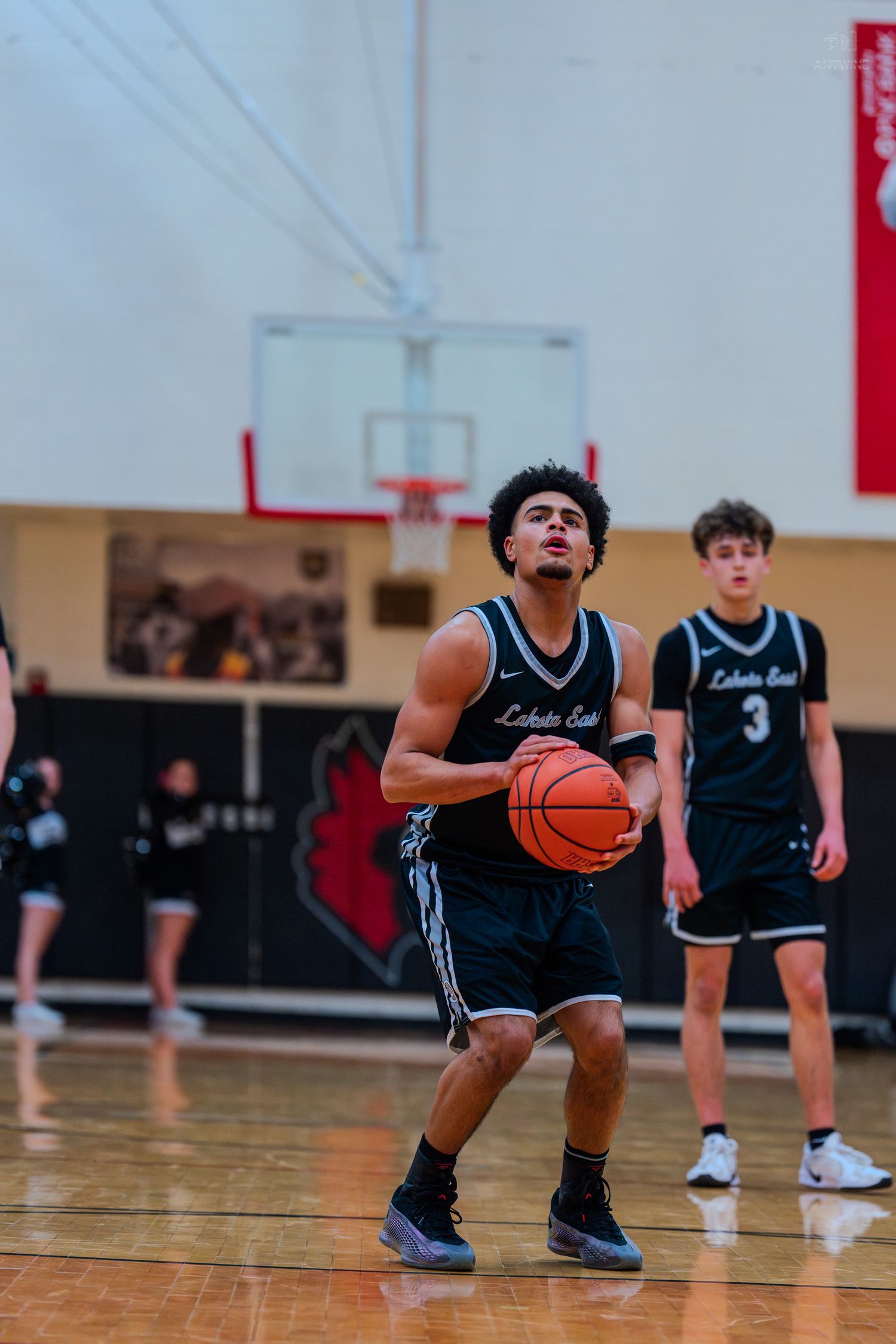 Lakota East #0 prepares free throw attempt in high school basketball game.