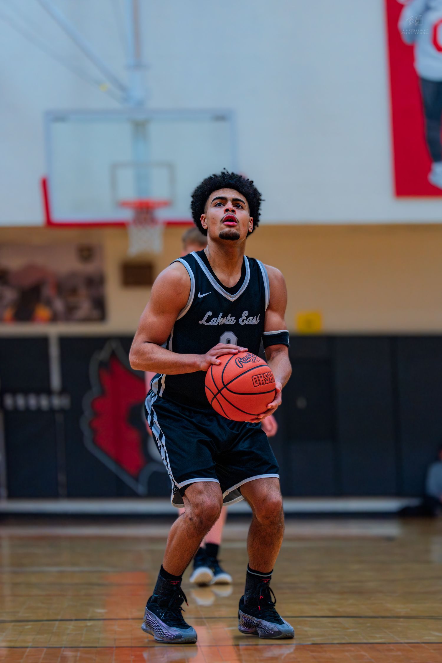 Lakota East basketball player #0 prepares for a free throw shot during an indoor high school game.