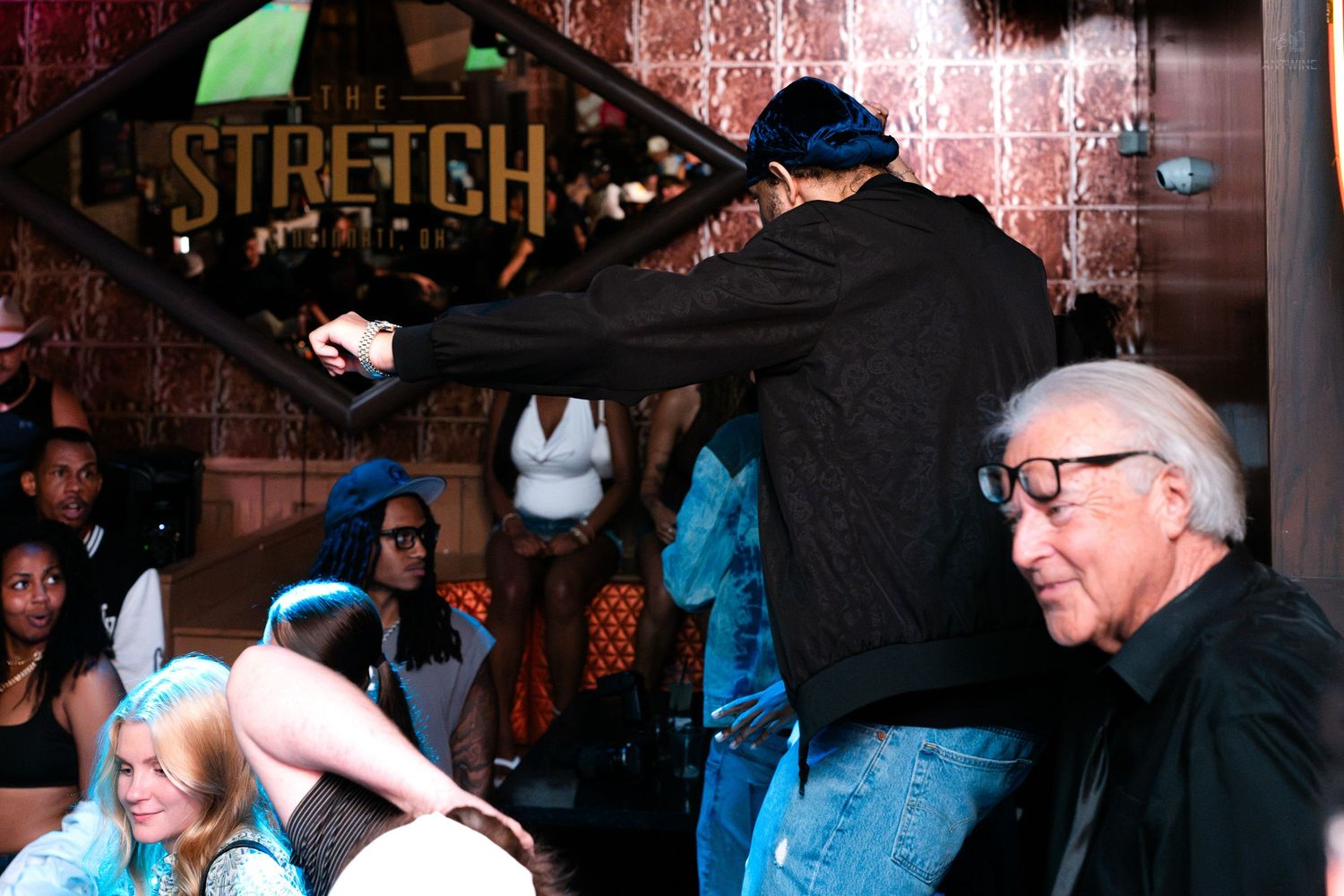 Energetic crowd dancing near entrance of The Stretch nightclub venue.