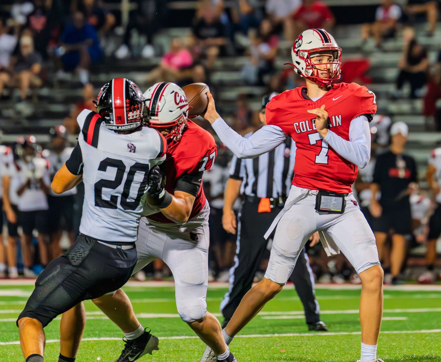Colerain quarterback #7 throws a pass under pressure during a high school football game.