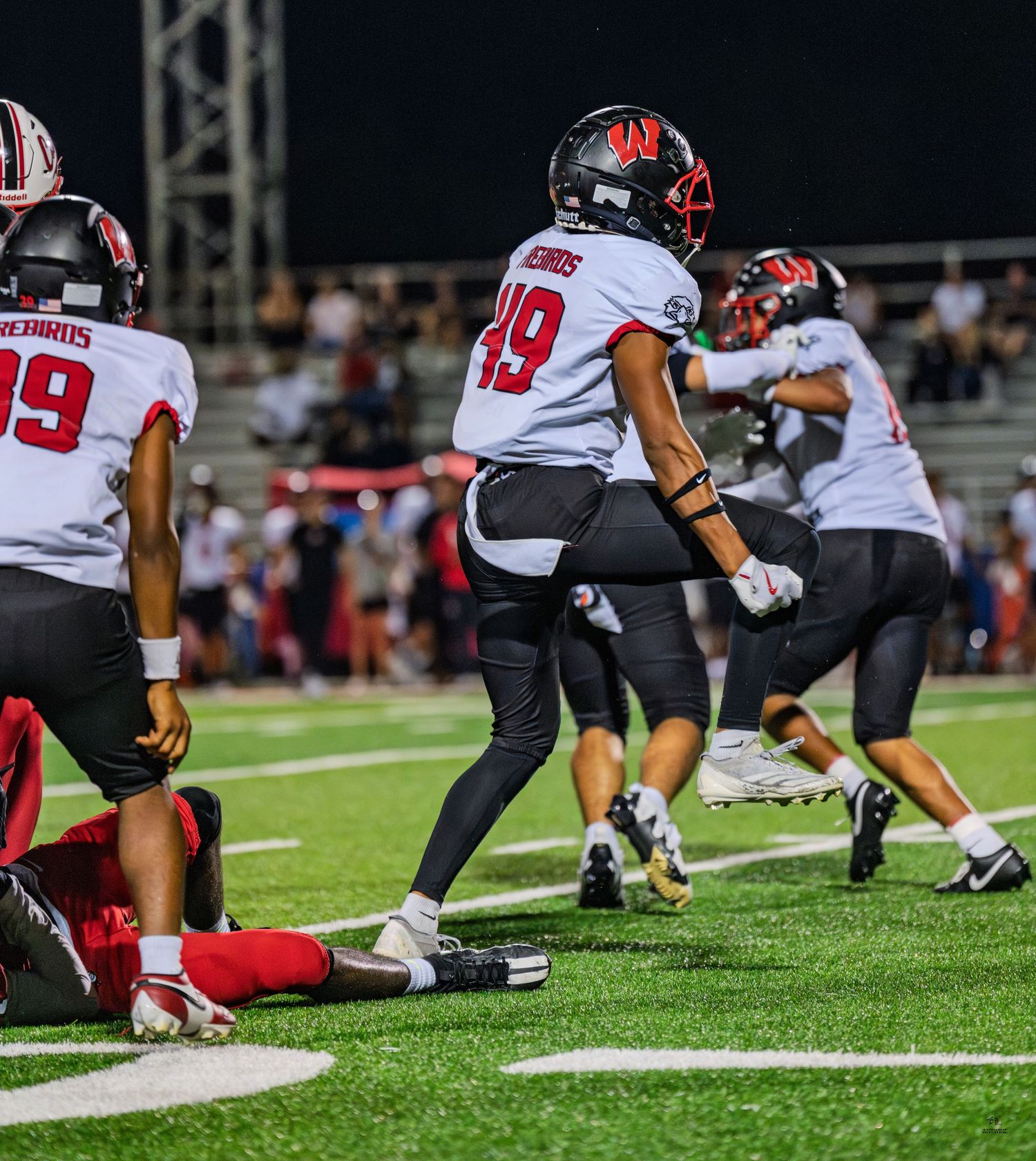 Colerain Cardinals player #49 celebrates after a play during a high school football game.