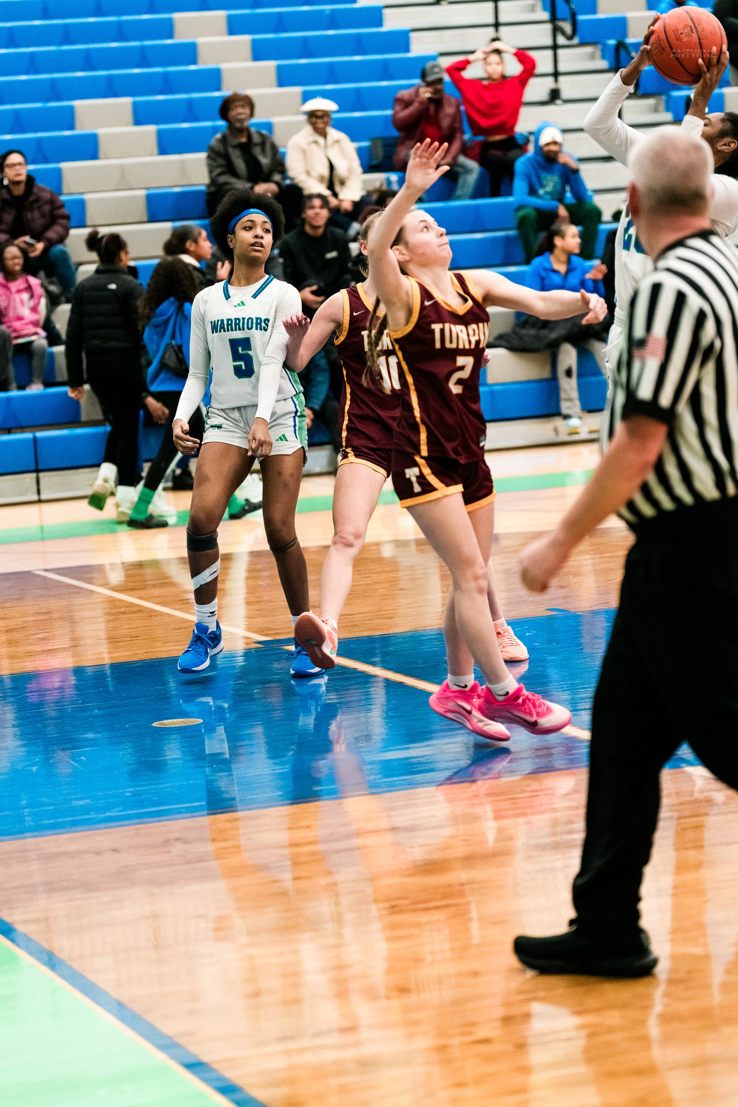 Turpin girls basketball player #2 jumps for a rebound during a game against the Warriors.