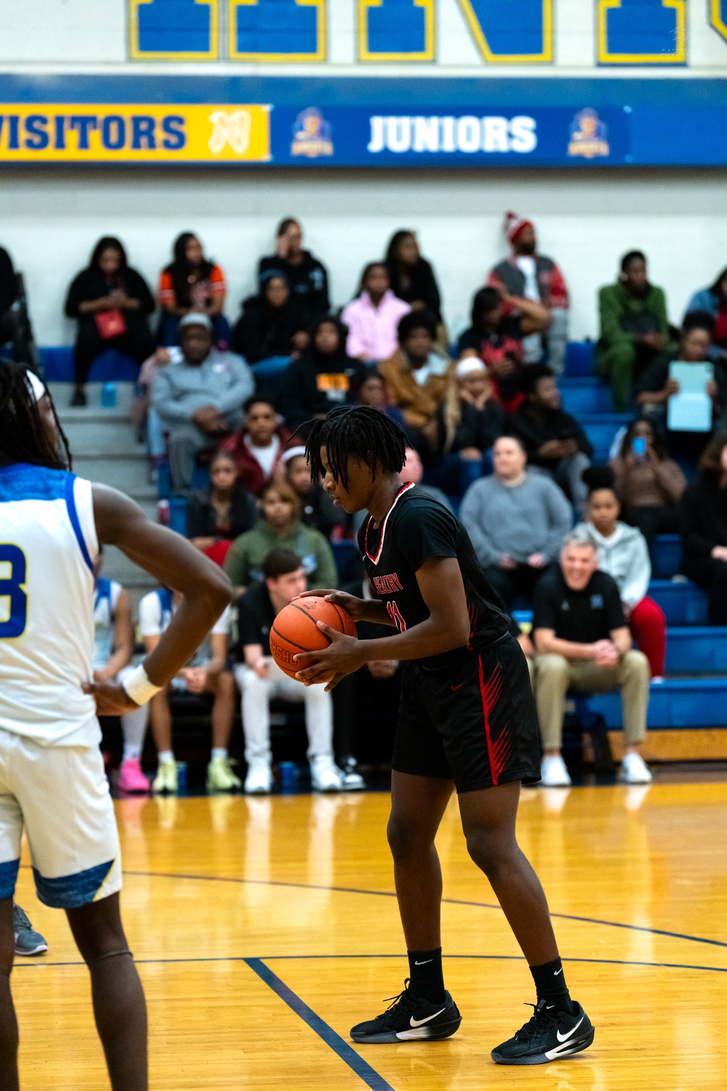 Mt. Healthy player prepares to shoot during competitive high school basketball game.
