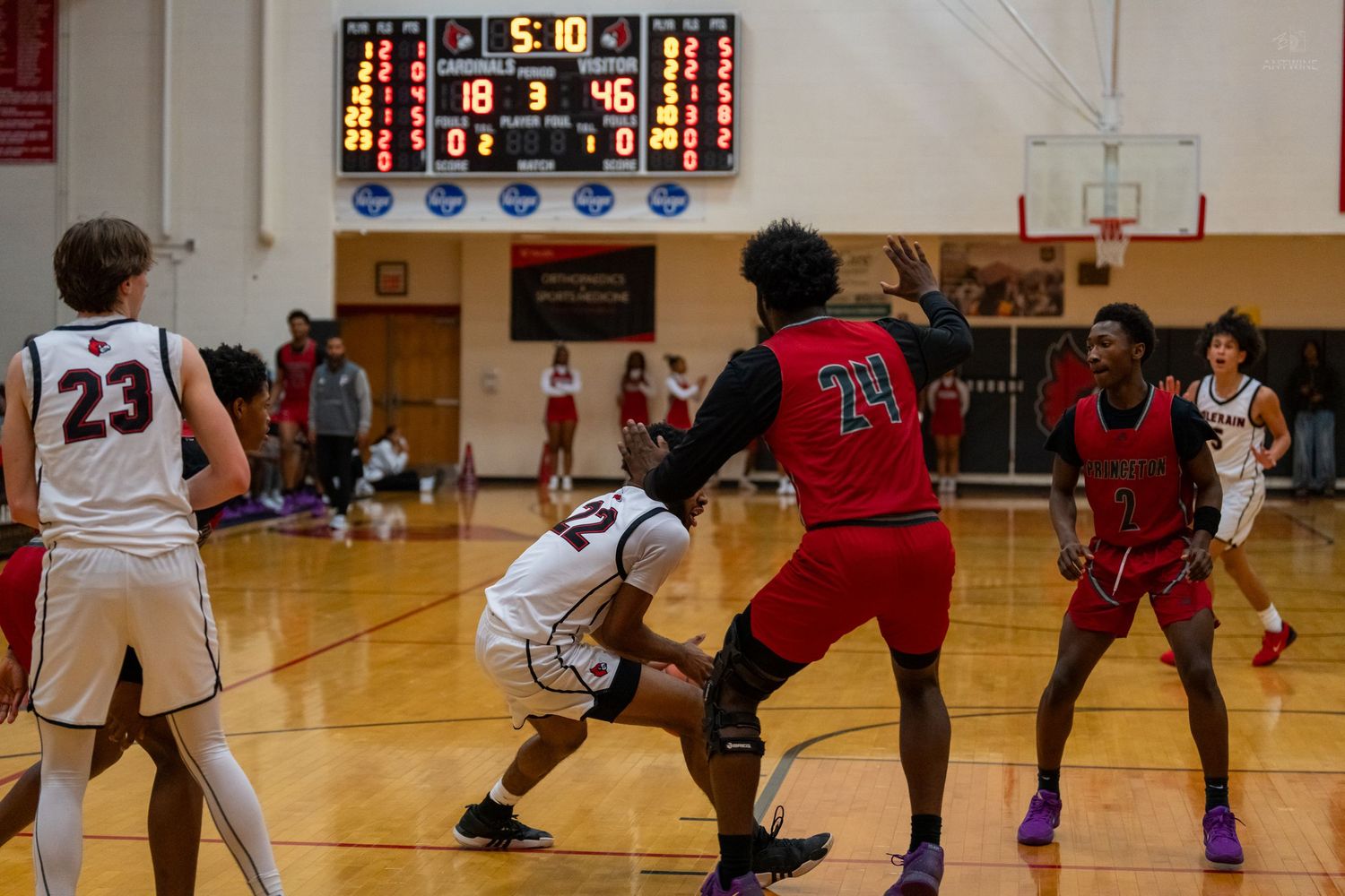Colerain basketball players compete against red-uniformed opponents with score 18-46 on the scoreboard.