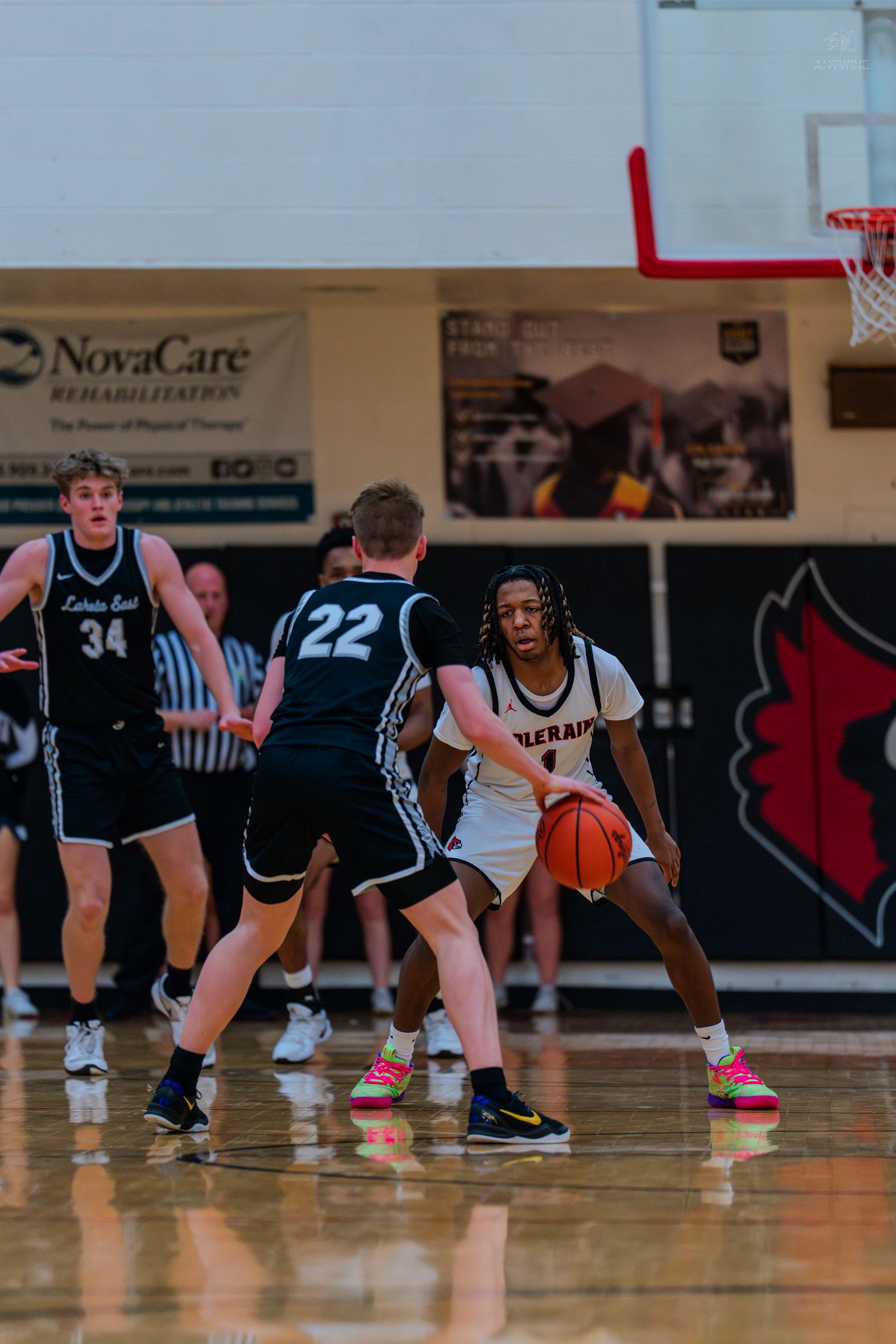 High school basketball players defend against Colerain opponent during an intense indoor game.