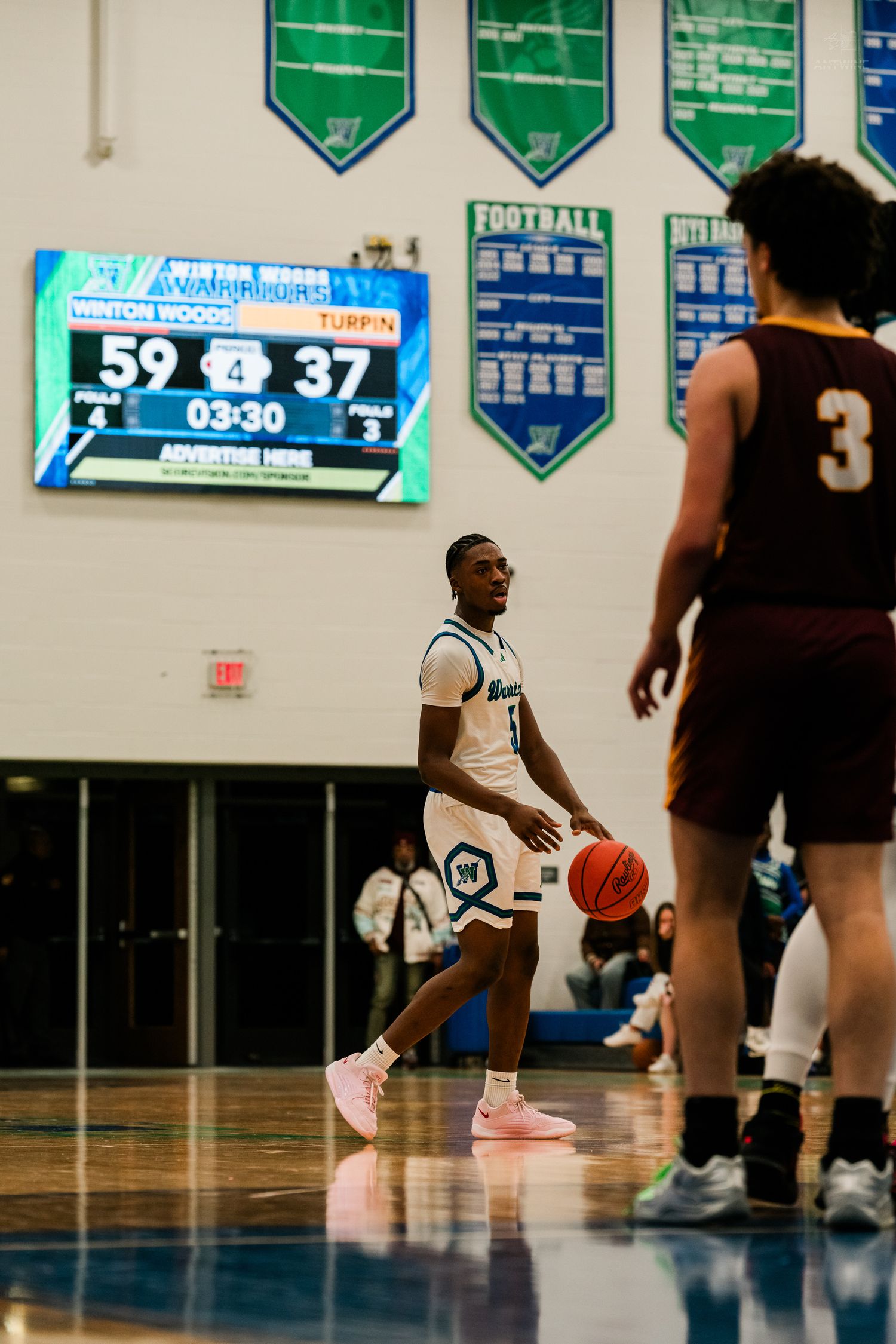 Player number 1 in white dribbles near halfcourt with the scoreboard showing Winton Woods leading Turpin 59-37.