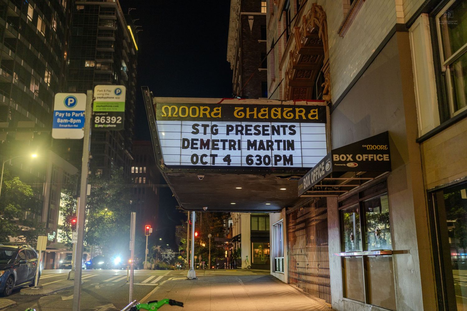 Moore Theatre marquee displays STG Presents Demetri Martin Oct 4 6:30PM on a Seattle street at night.
