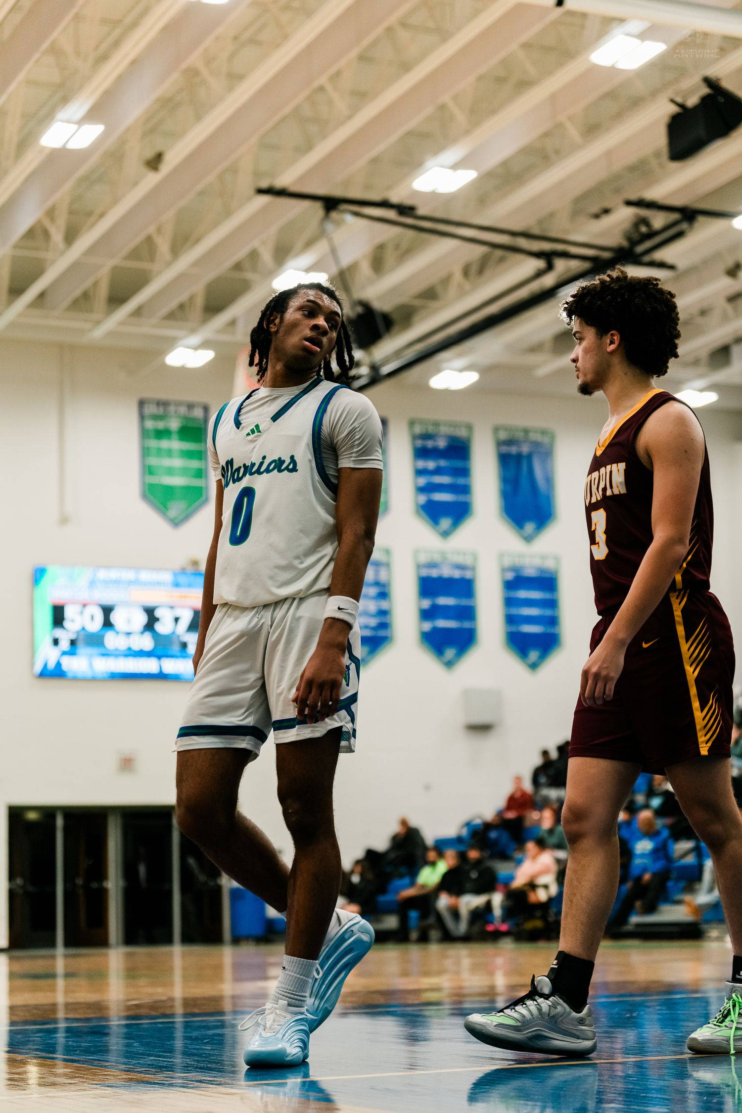 Winton Woods Warriors player #0 faces off against Turpin player #3 during a high school basketball game.