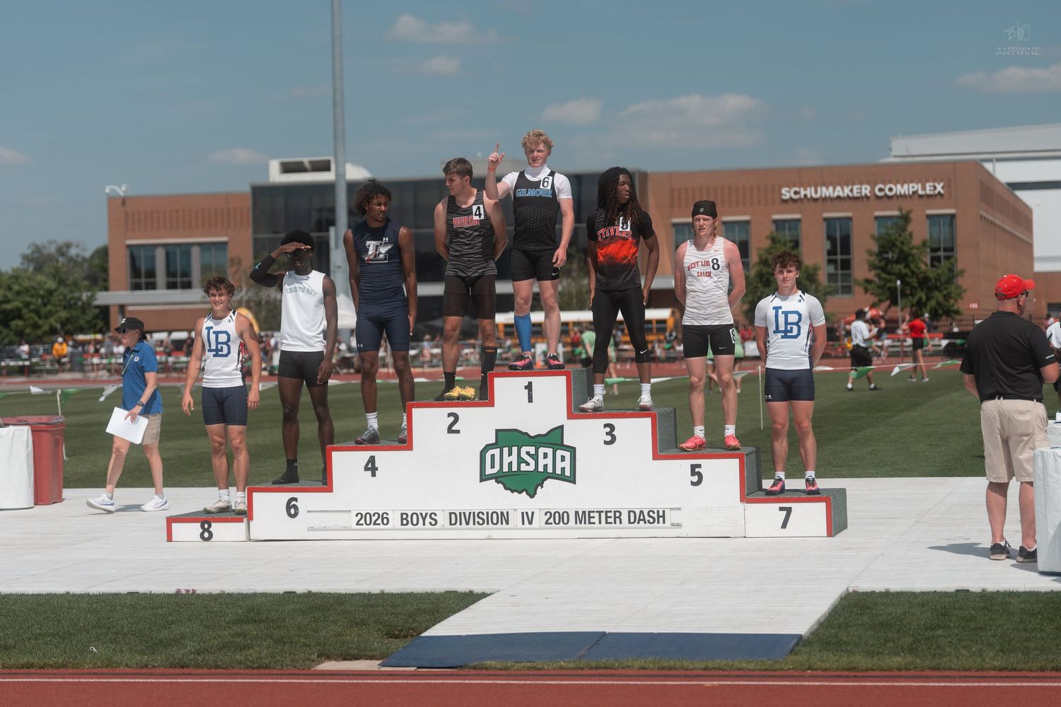 Boys Division IV 200 meter dash award ceremony at OHSAA track meet on numbered podium steps.