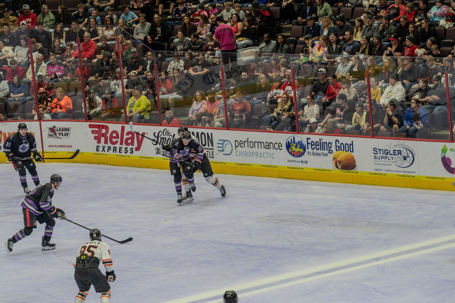 Hockey players compete on the ice at Heritage Bank Center arena during a professional hockey game.