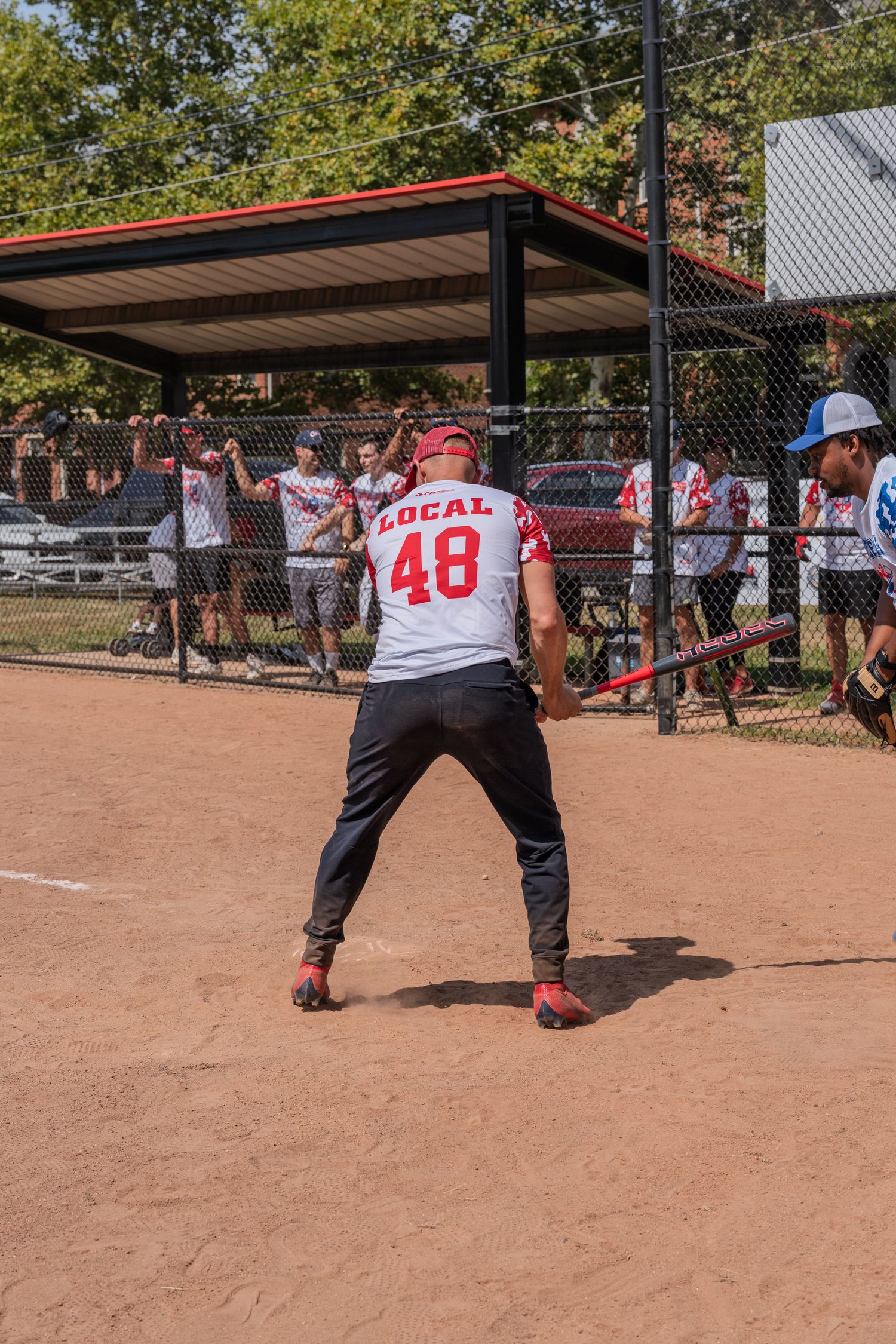 Baseball player in Local 48 jersey batting at home plate during game.