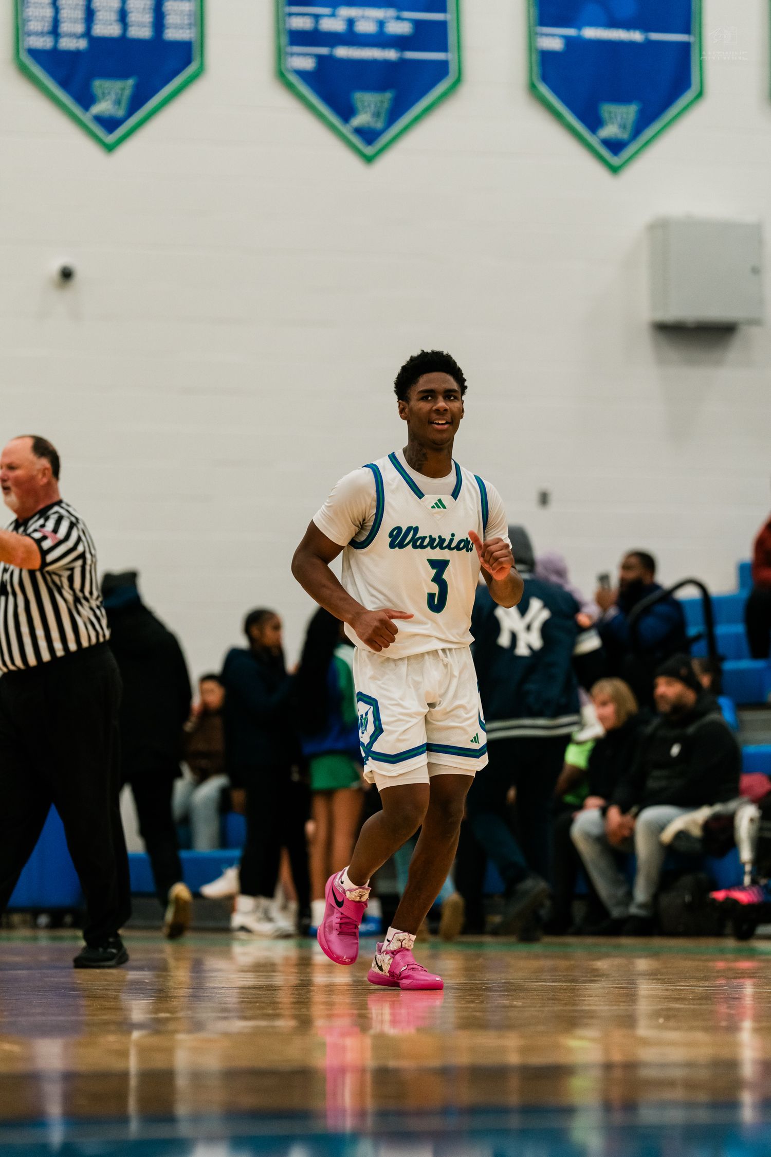 Warriors high school basketball player #3 in white Adidas uniform jogs on court during a game.