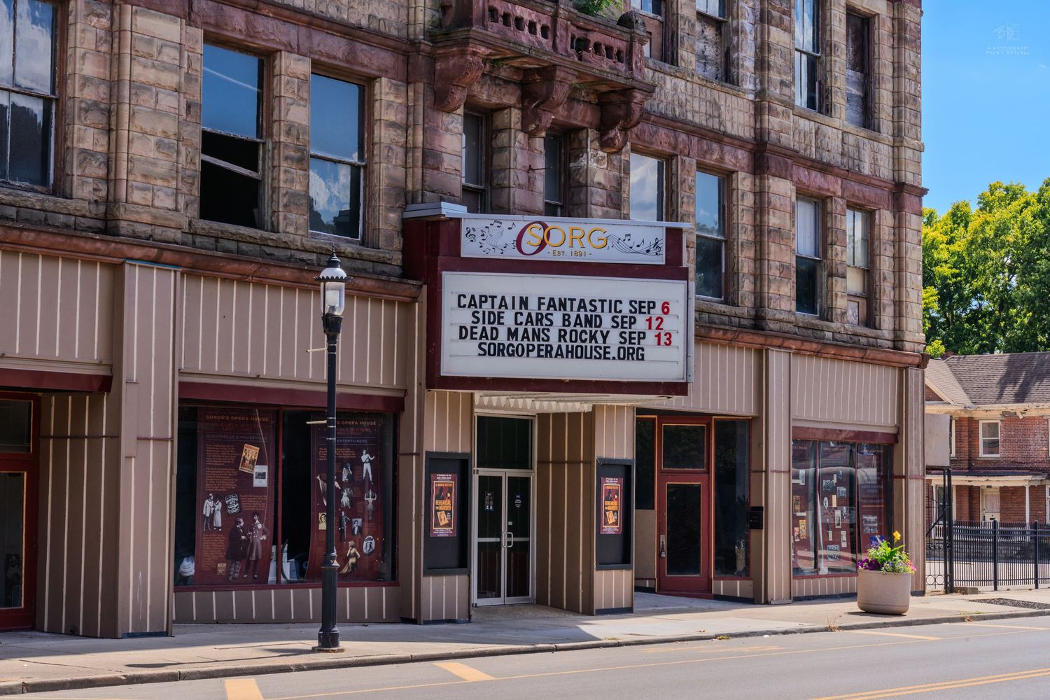 Historic Sorg Opera House theater facade with marquee sign on a sunny small town street.