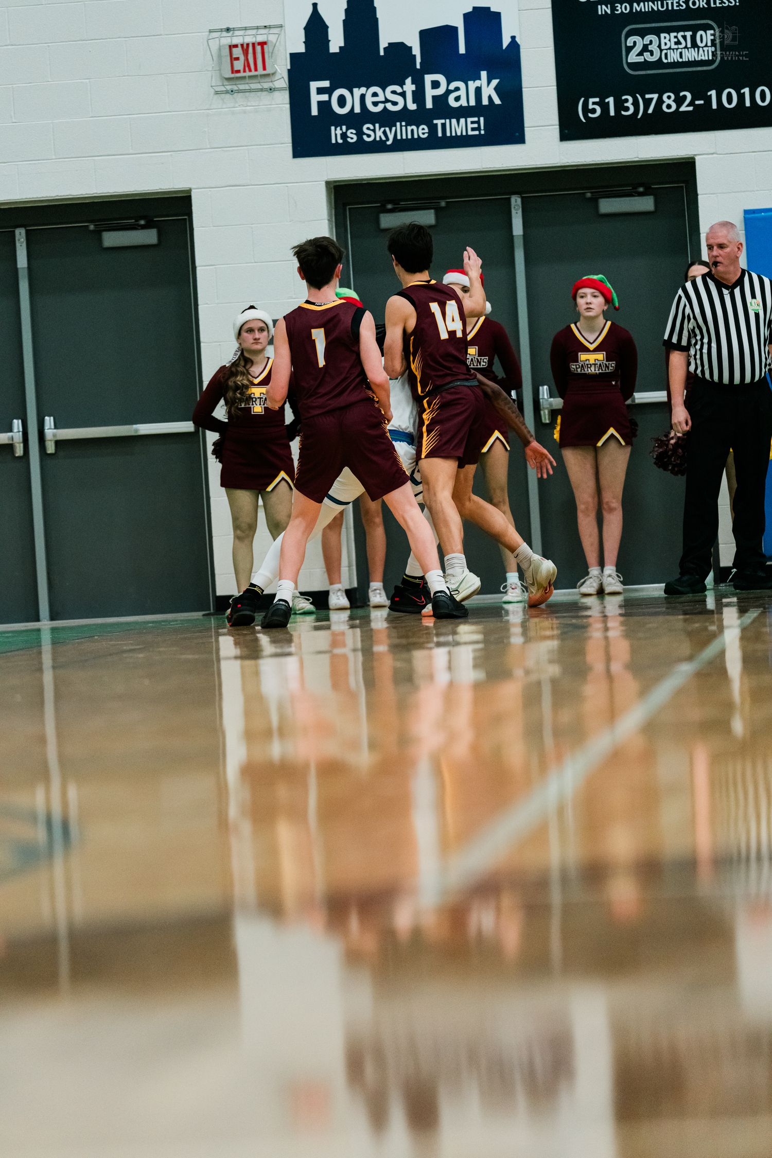 Turpin high school basketball players celebrate near cheerleaders at Forest Park Skyline Time gymnasium.