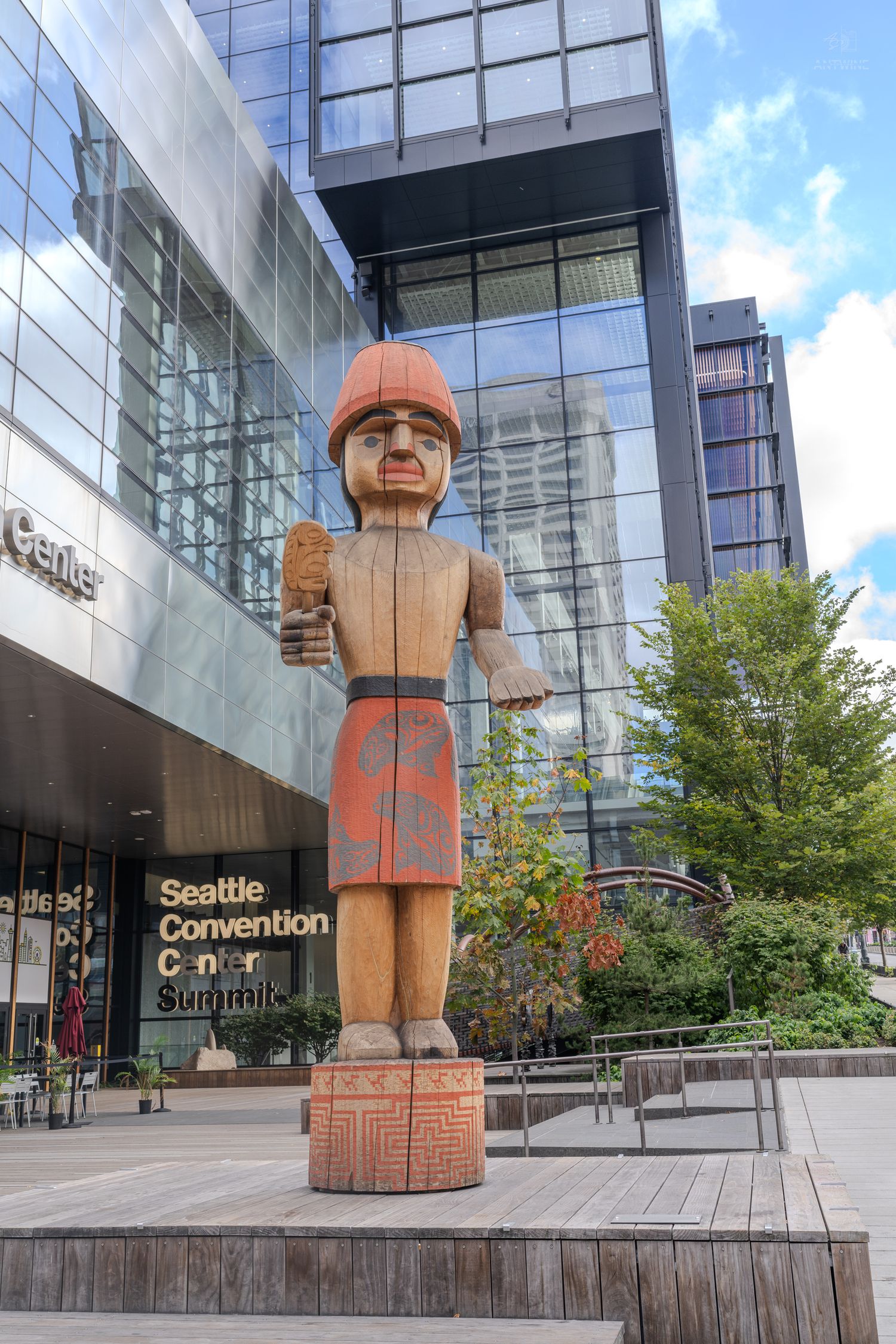 Native American totem pole wooden sculpture outside Seattle Convention Center Summit building.