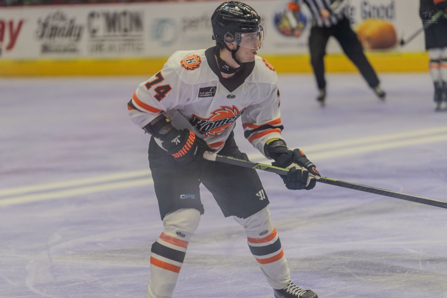 Close-up of hockey player number 74 in position during a professional ice hockey game.