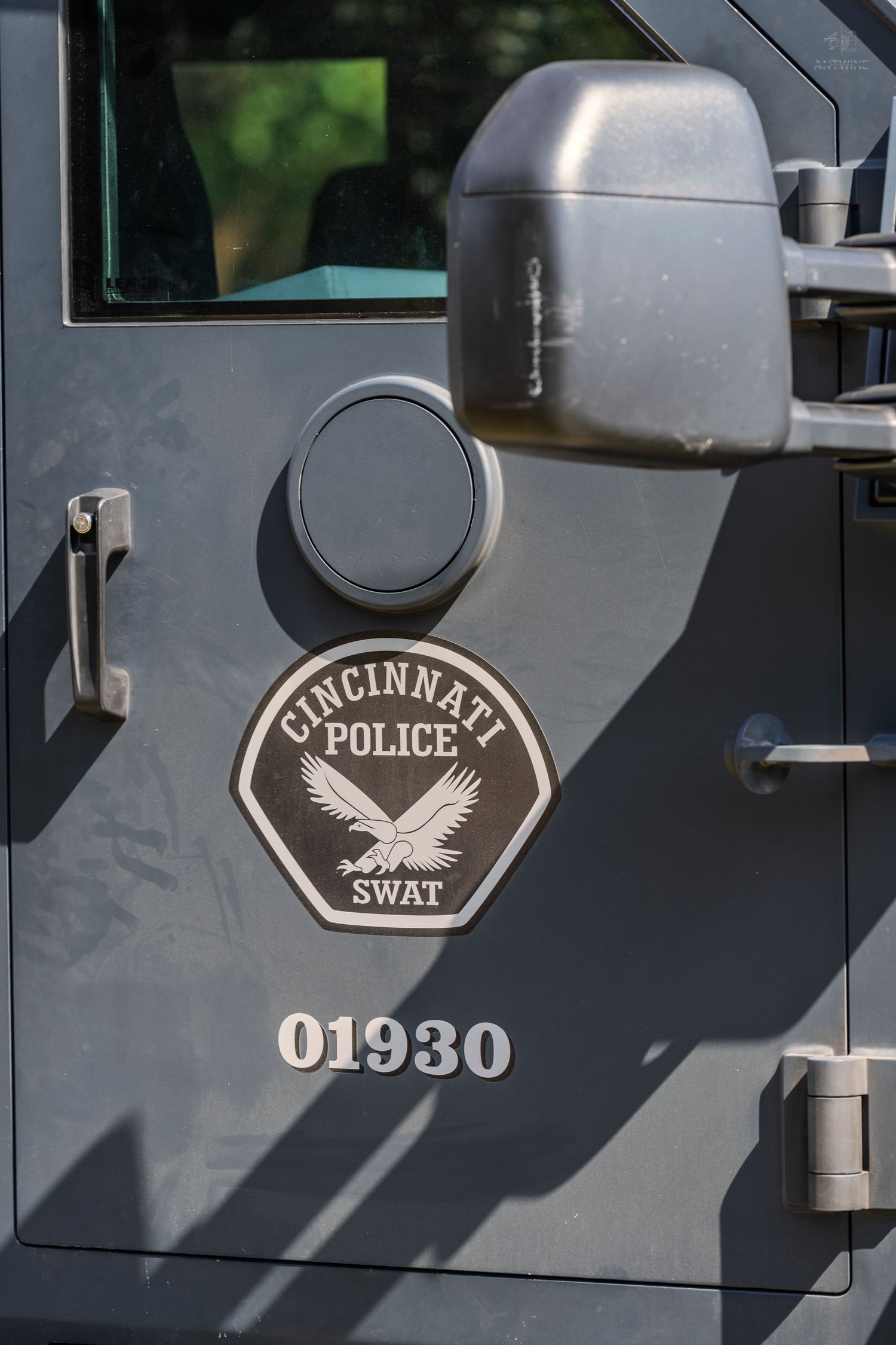 Cincinnati Police SWAT vehicle door with badge logo and unit number 01930 on gray armored truck.