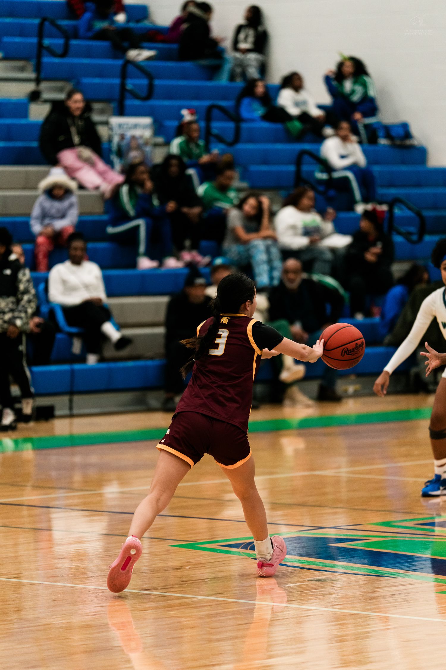 Turpin girls basketball player #3 in maroon uniform passes ball during high school basketball game.
