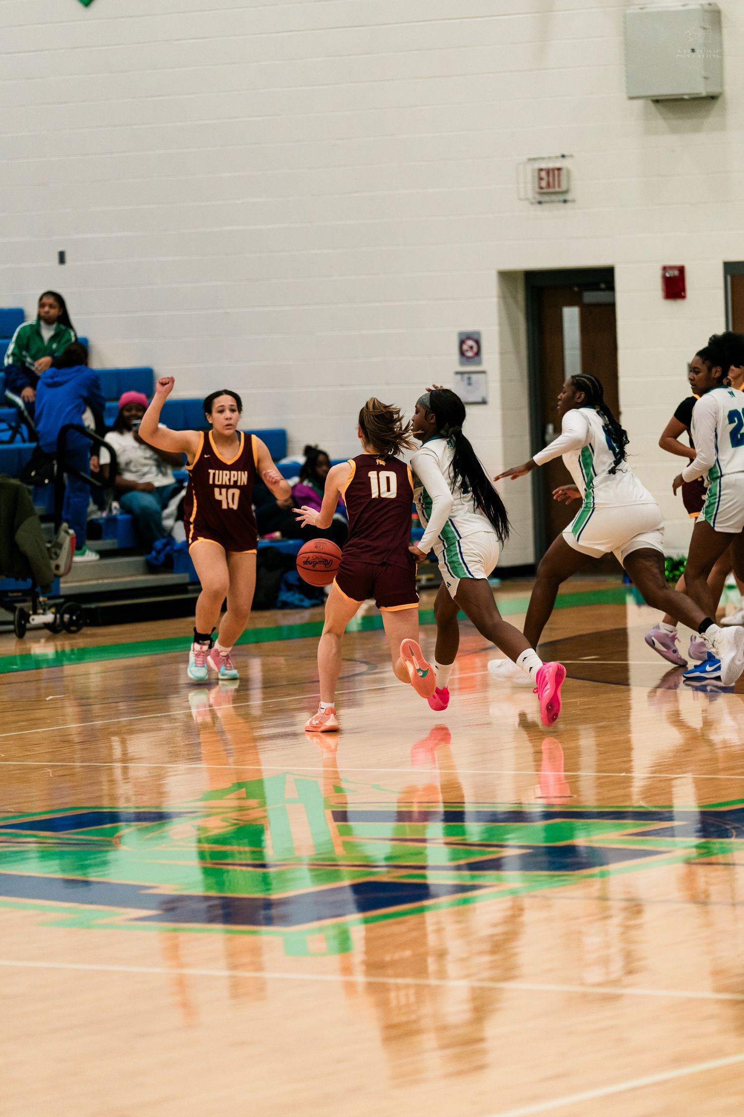 Turpin number 10 dribbles upcourt as Warriors defenders close in during a girls high school basketball game.