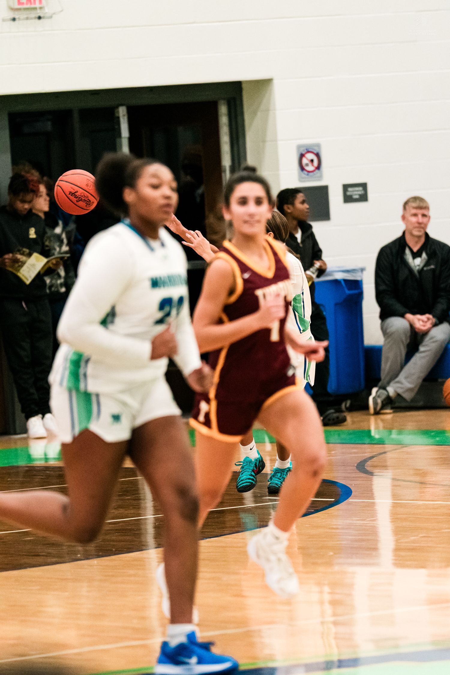 Warriors player #21 races downcourt against Turpin opponent during girls high school basketball game.