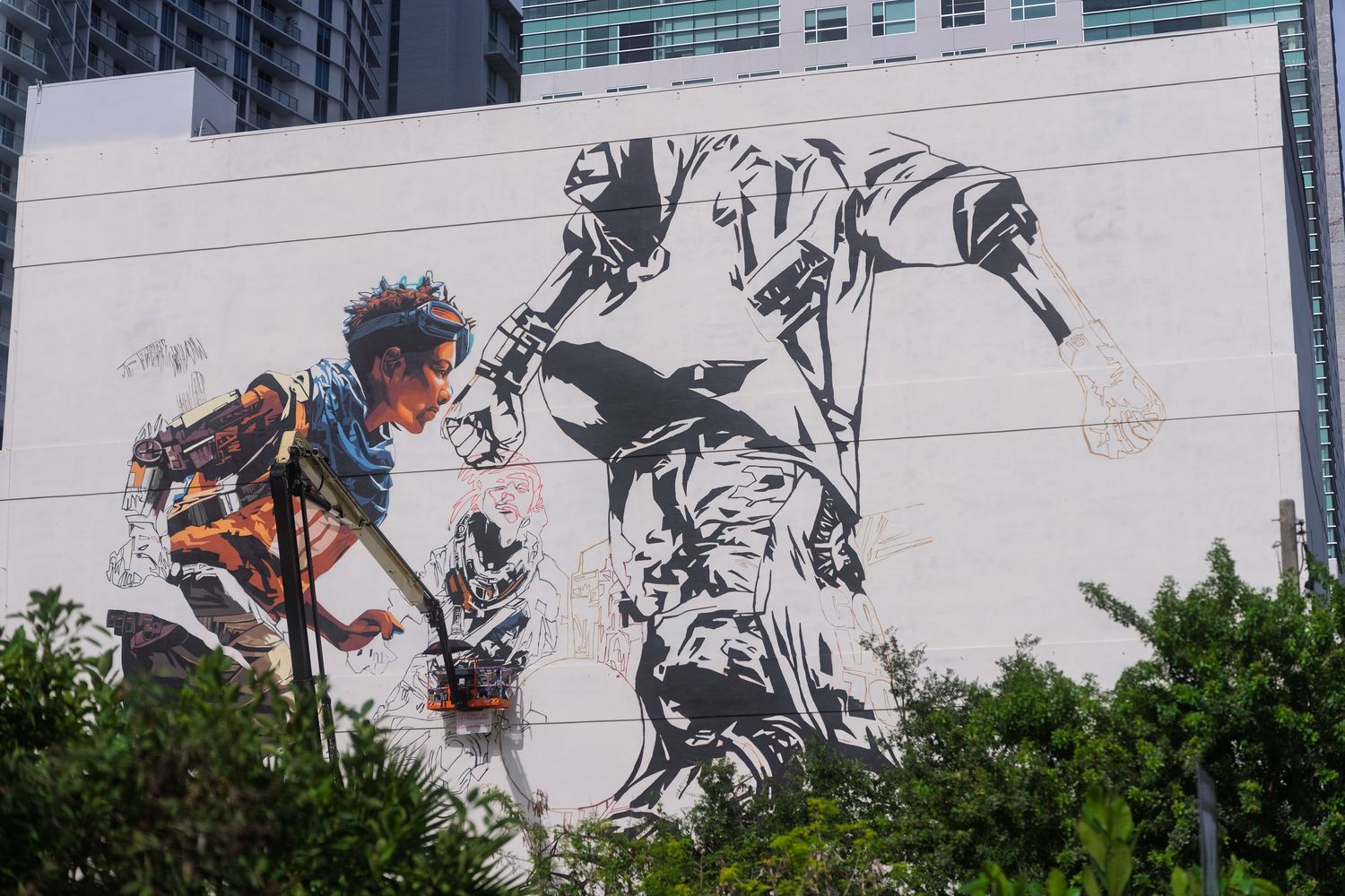 Vibrant urban street art mural featuring dynamic figures painted on a white building exterior wall.