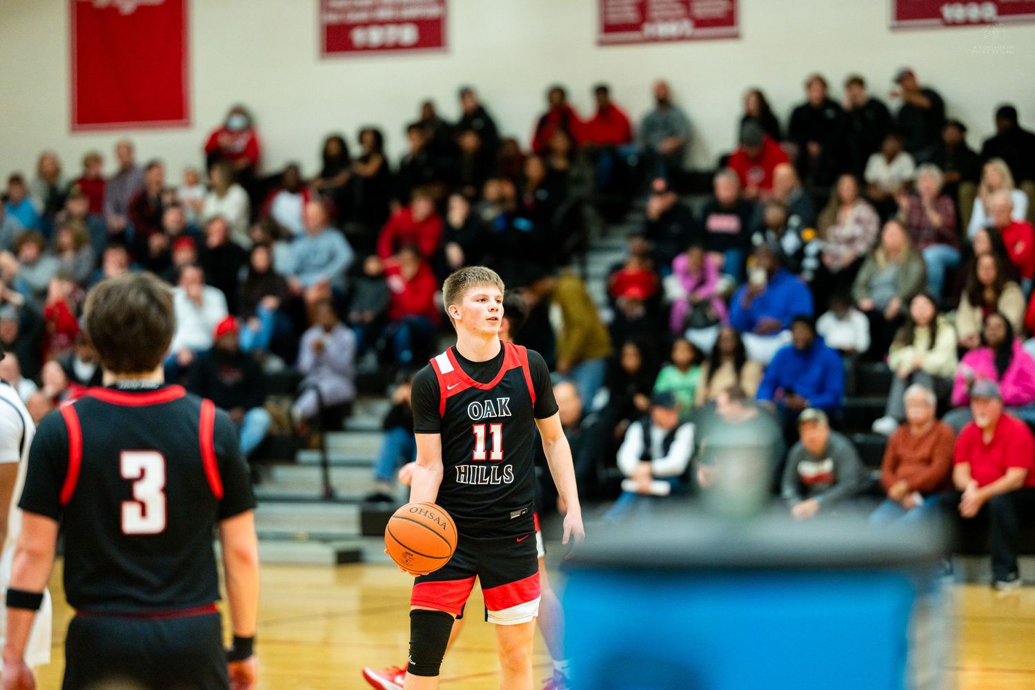 High school basketball player number 11 prepares free throw during Cardinals home game.