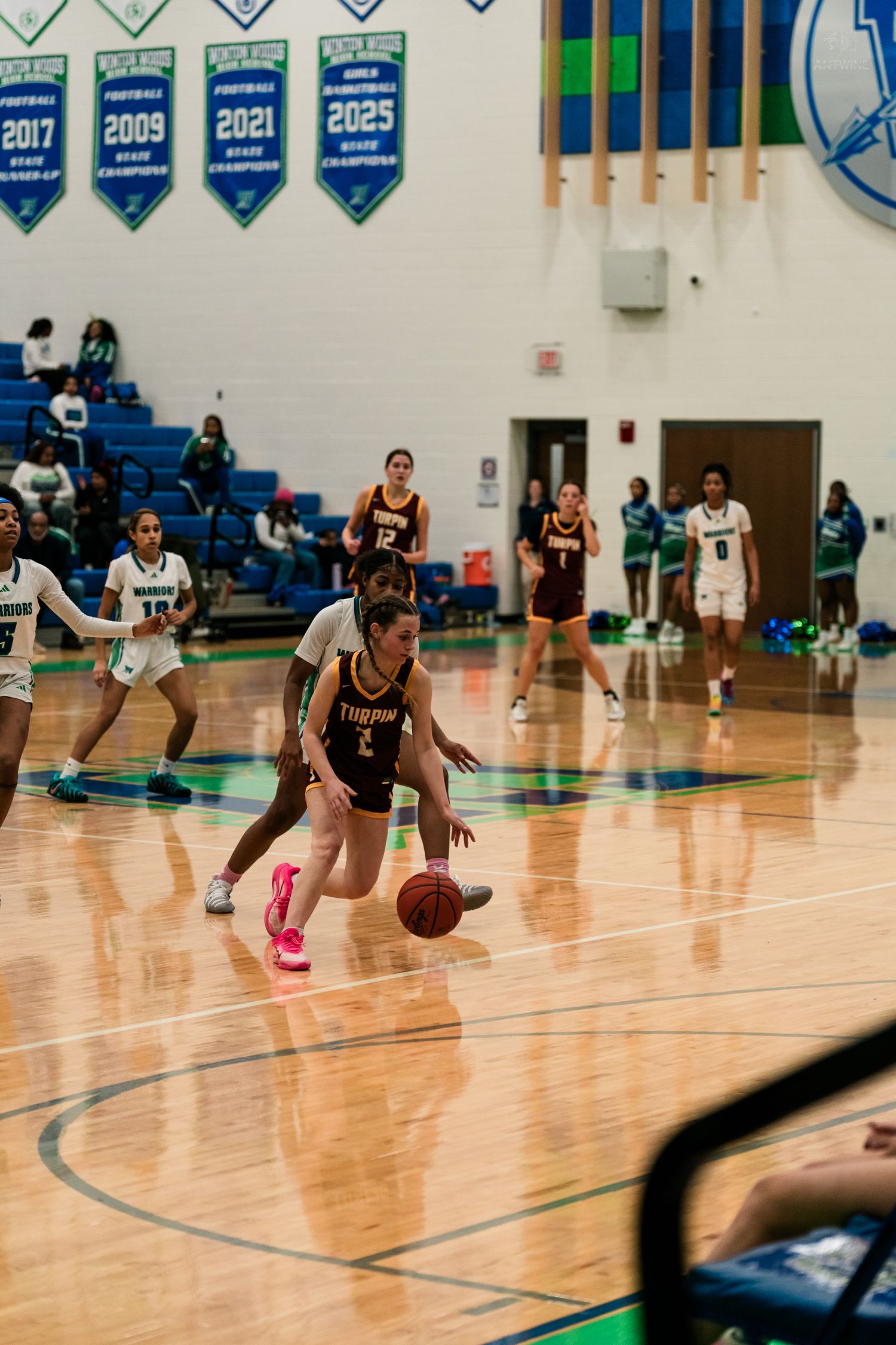 A Turpin girls basketball player dribbles past defenders during a game against Winton Woods.