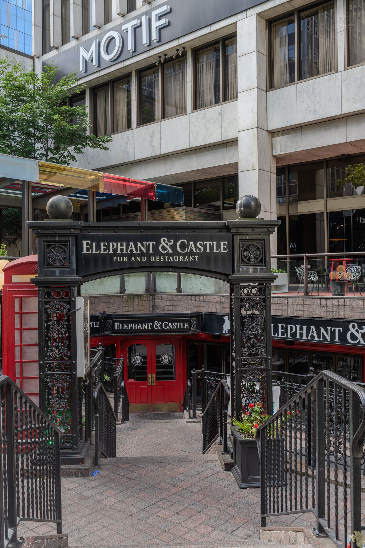 Elephant & Castle Pub and Restaurant entrance with ornate black iron gates and red phone box in Seattle.