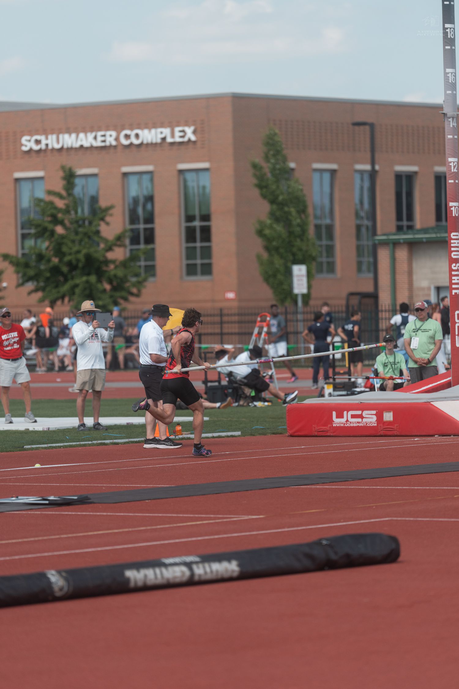 Pole vaulter plants during approach at Ohio State Schumaker Complex track and field competition.