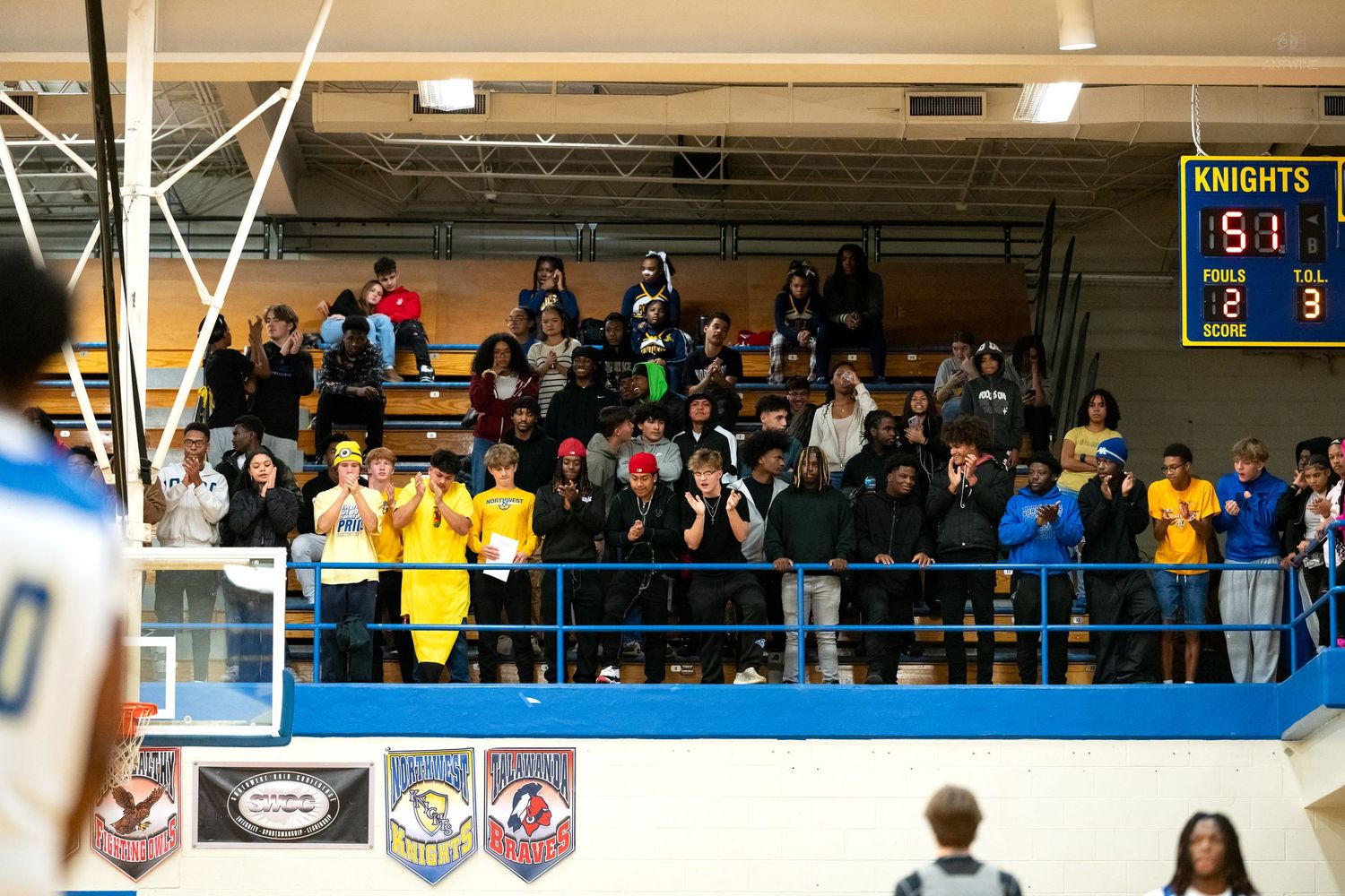 Students and fans cheer from upper bleachers as Knights lead 5-3 on scoreboard.