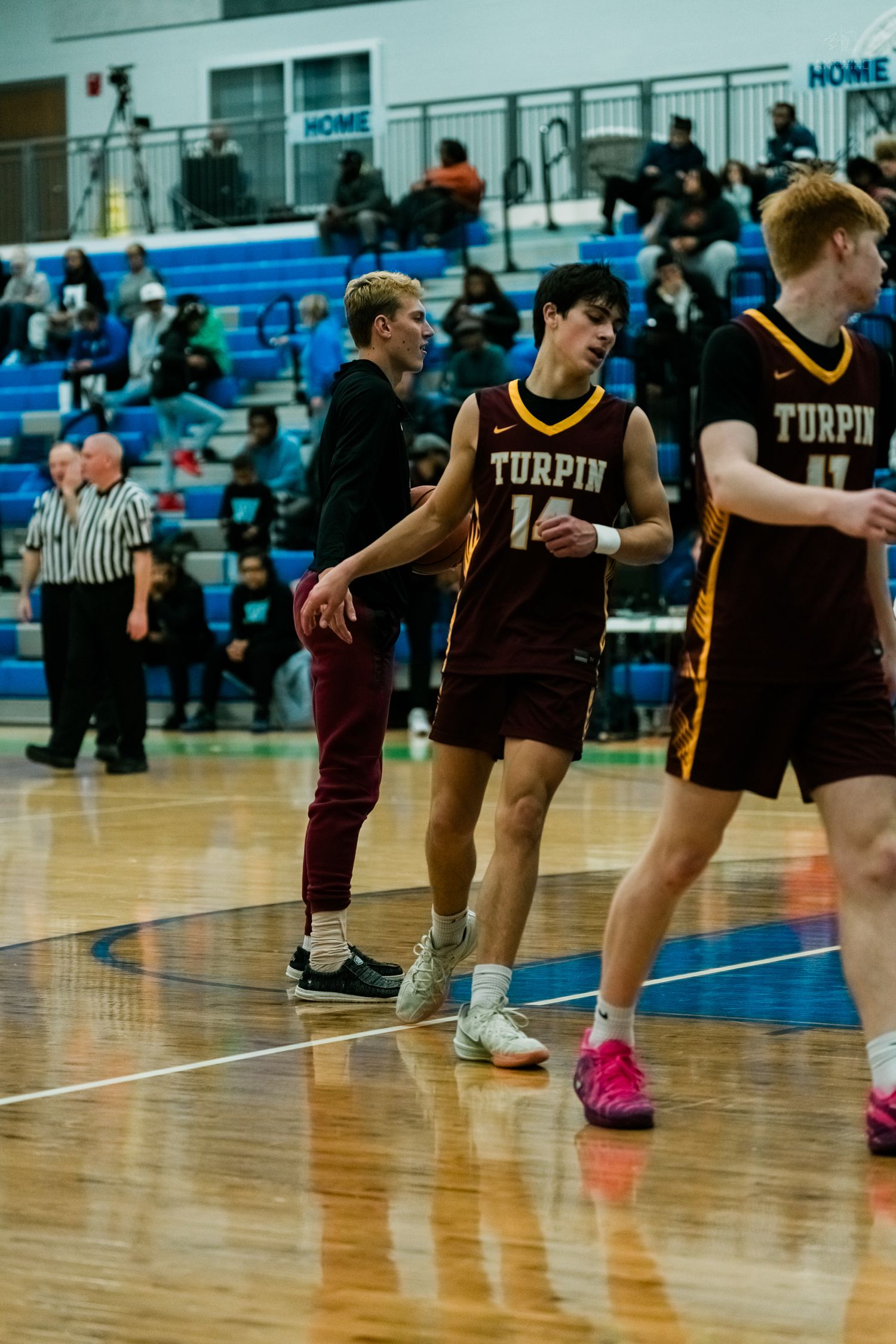 Turpin high school basketball players warming up on indoor court during pregame.