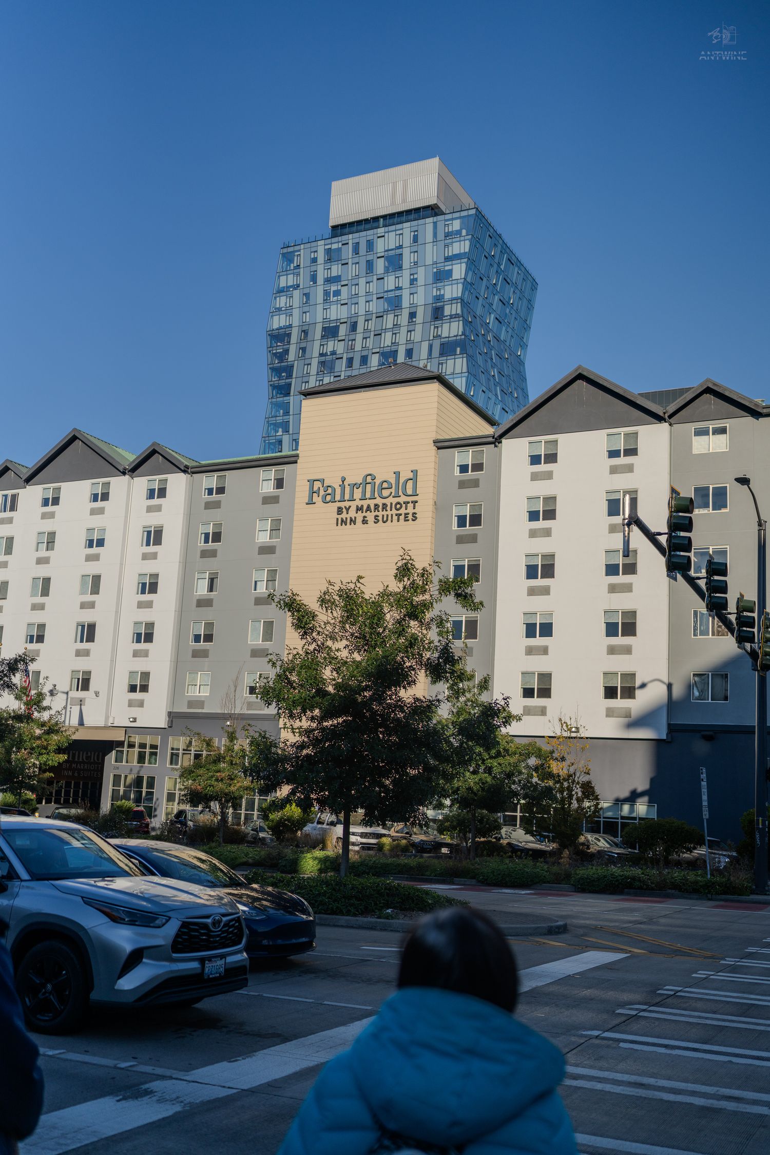 Fairfield by Marriott Inn and Suites hotel building with a modern glass skyscraper rising behind it in Seattle.