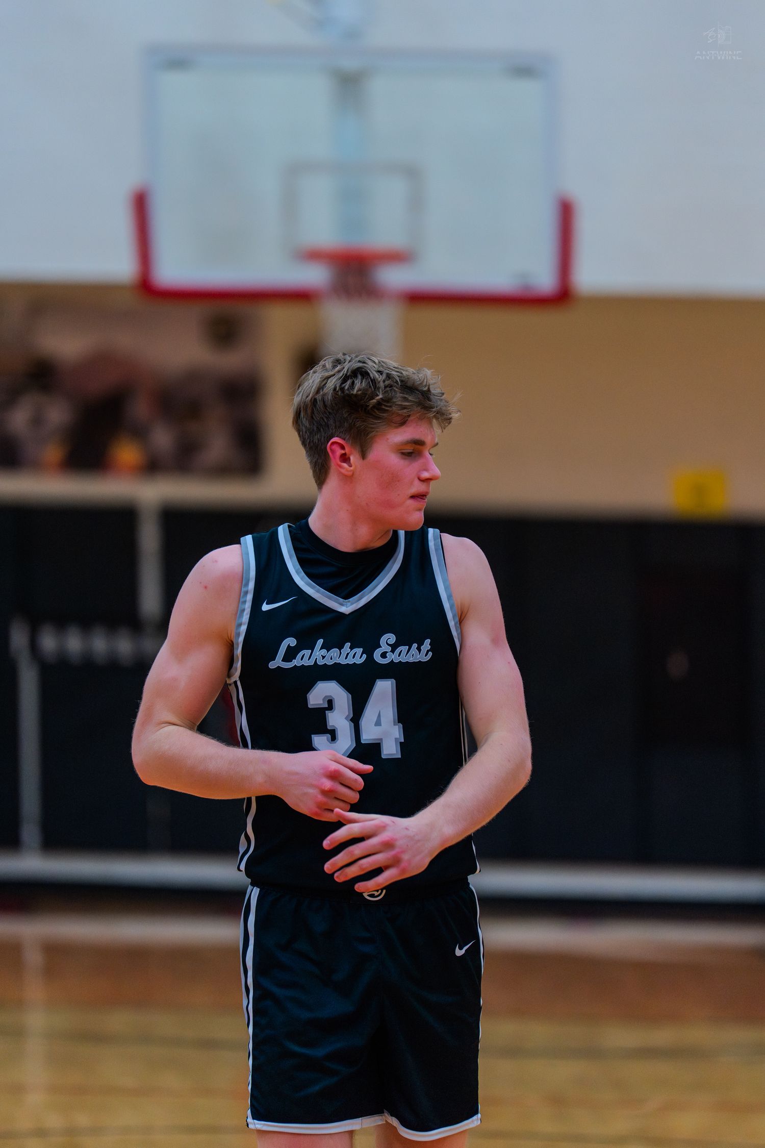 Lakota East player number 34 stands on basketball court during game.