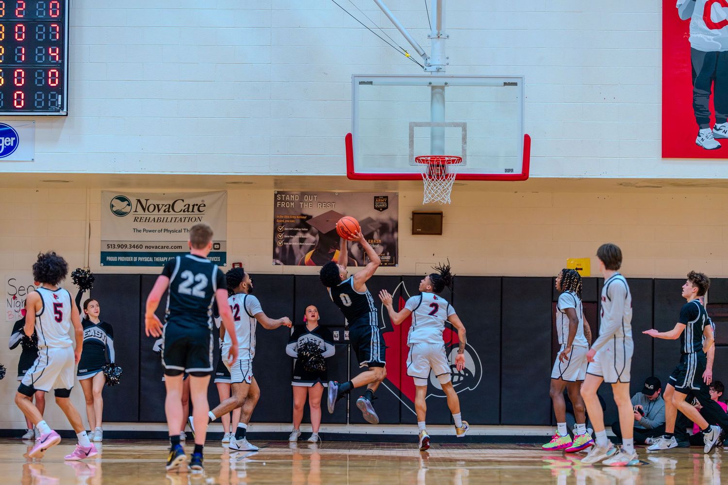 Players compete near the basket during a high school basketball game at Colerain gymnasium.