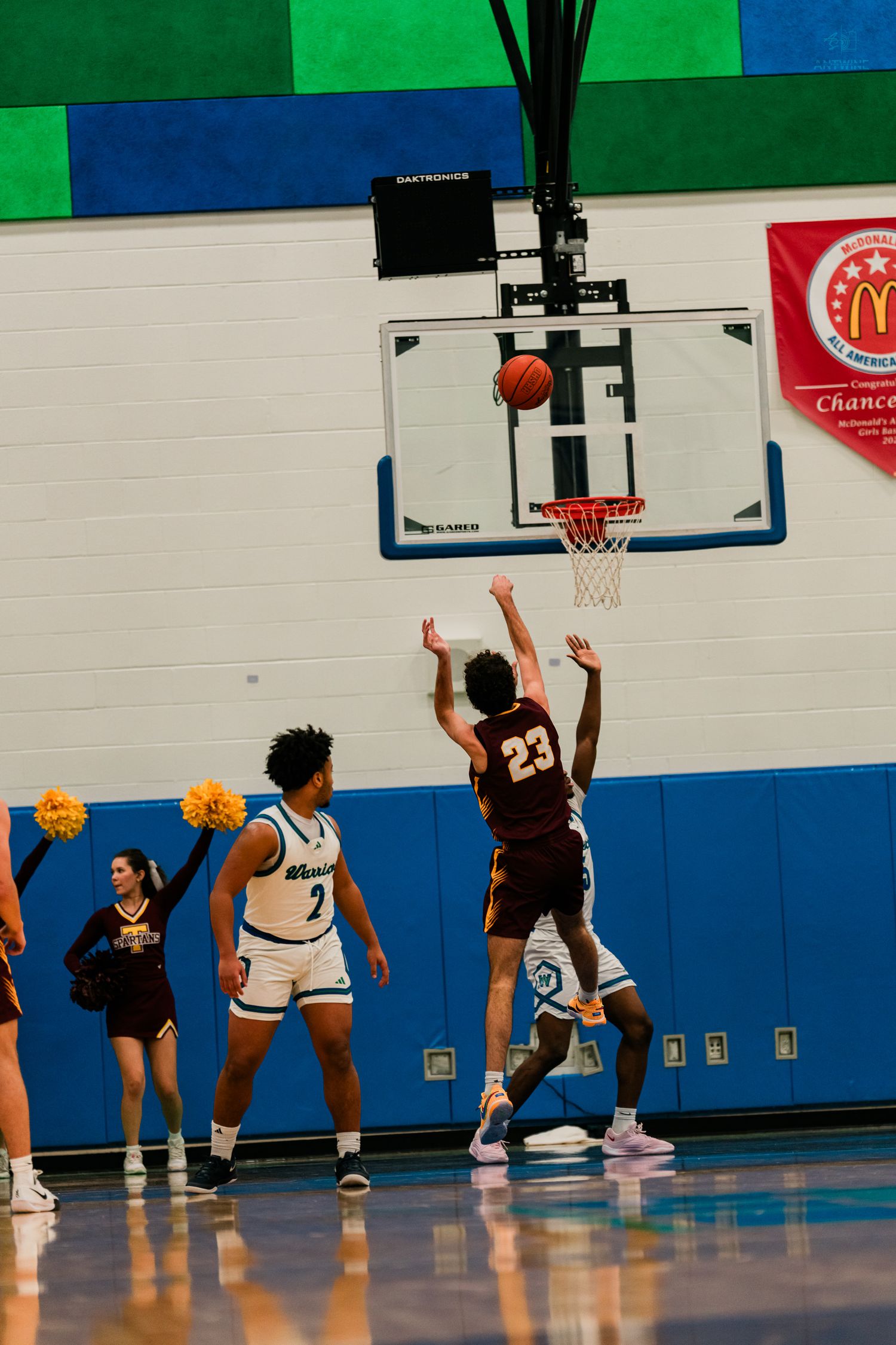 Turpin player #23 attempts a shot over Winton Woods Warriors defenders during a high school game.