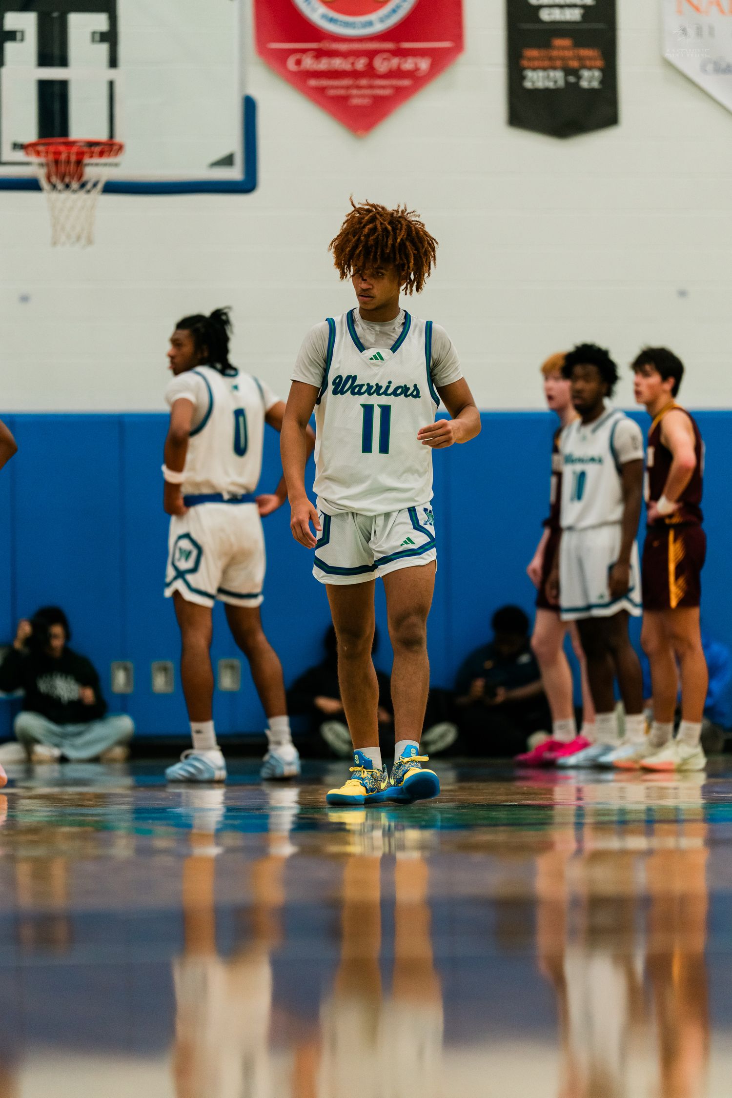 Winton Woods Warriors basketball player #11 walks on the court during a high school basketball game.