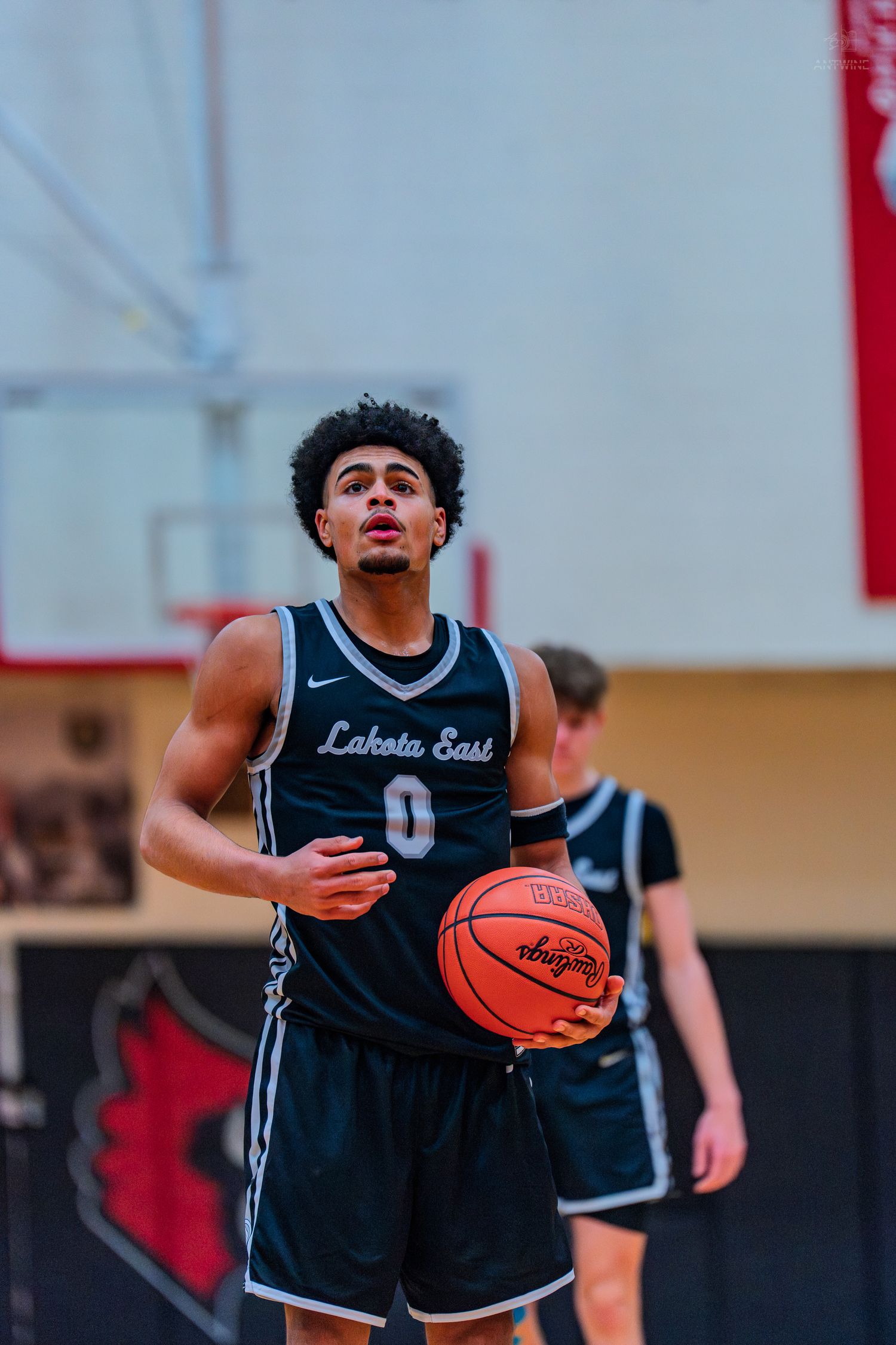 Lakota East player number 0 prepares for a free throw shot during a high school basketball game.
